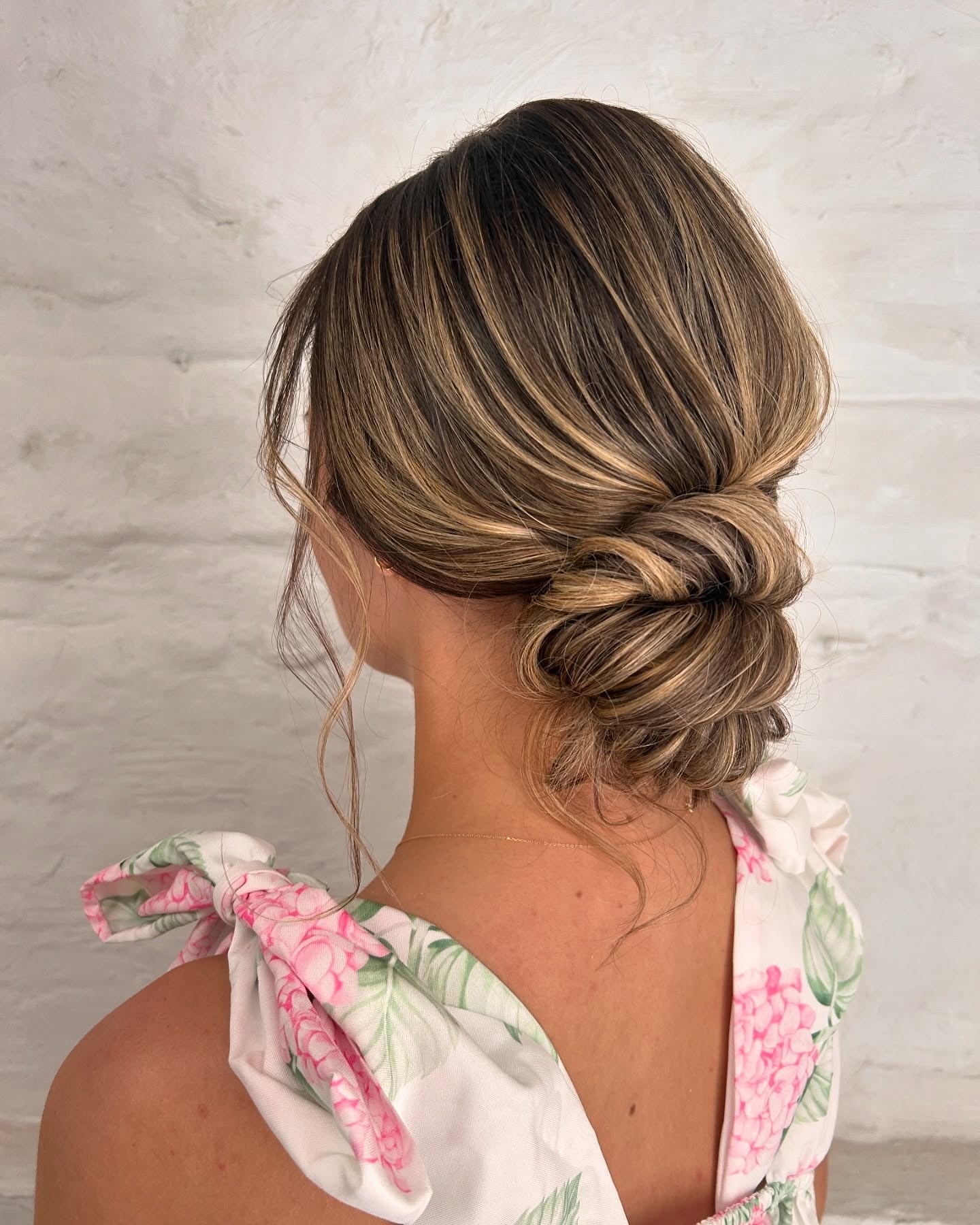 14. Knotted Low Bun on Highlighted Brunette (Summer Hairstyles)