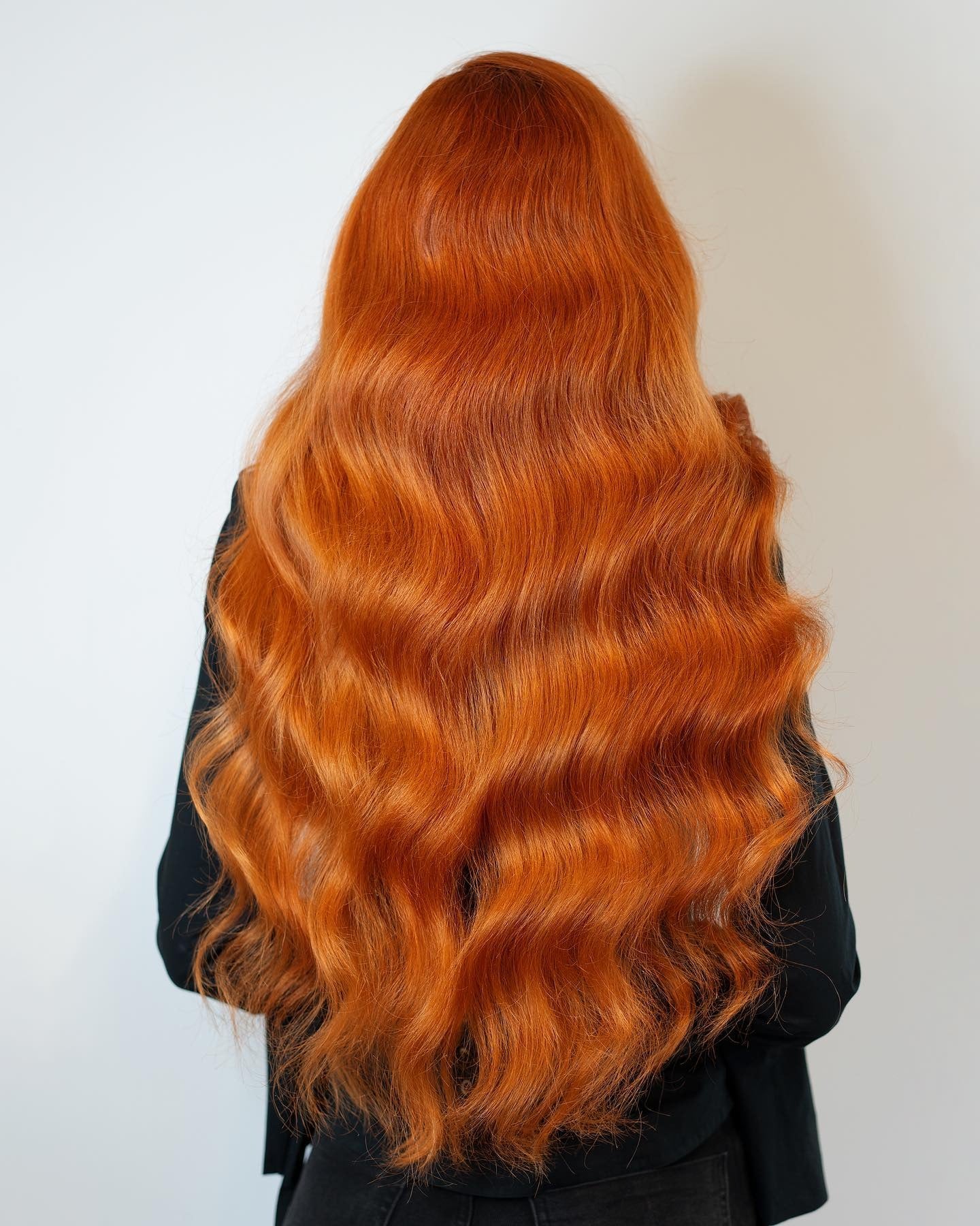 6. Deep Orange Waves on Long Layers (Orange Hair Color)