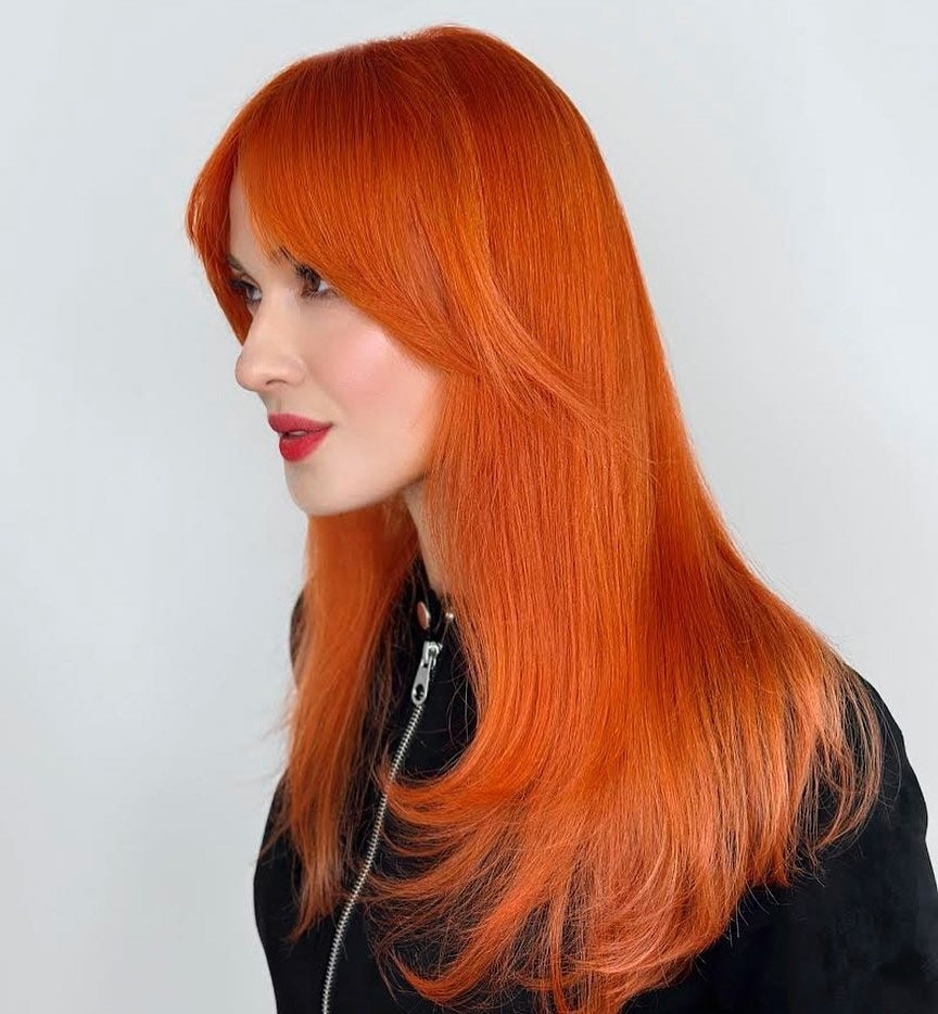 15. Straight Layers with Long Curtain Fringe in Tangerine Glow (Orange Hair Color)