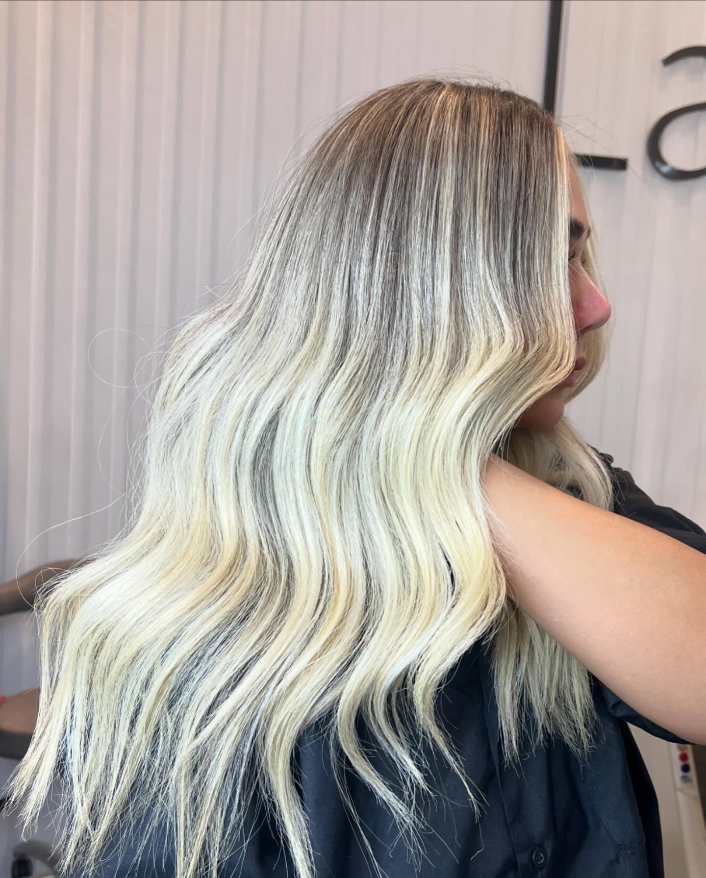 7. Rooted Icy Blonde Waves (Light Hair Color)