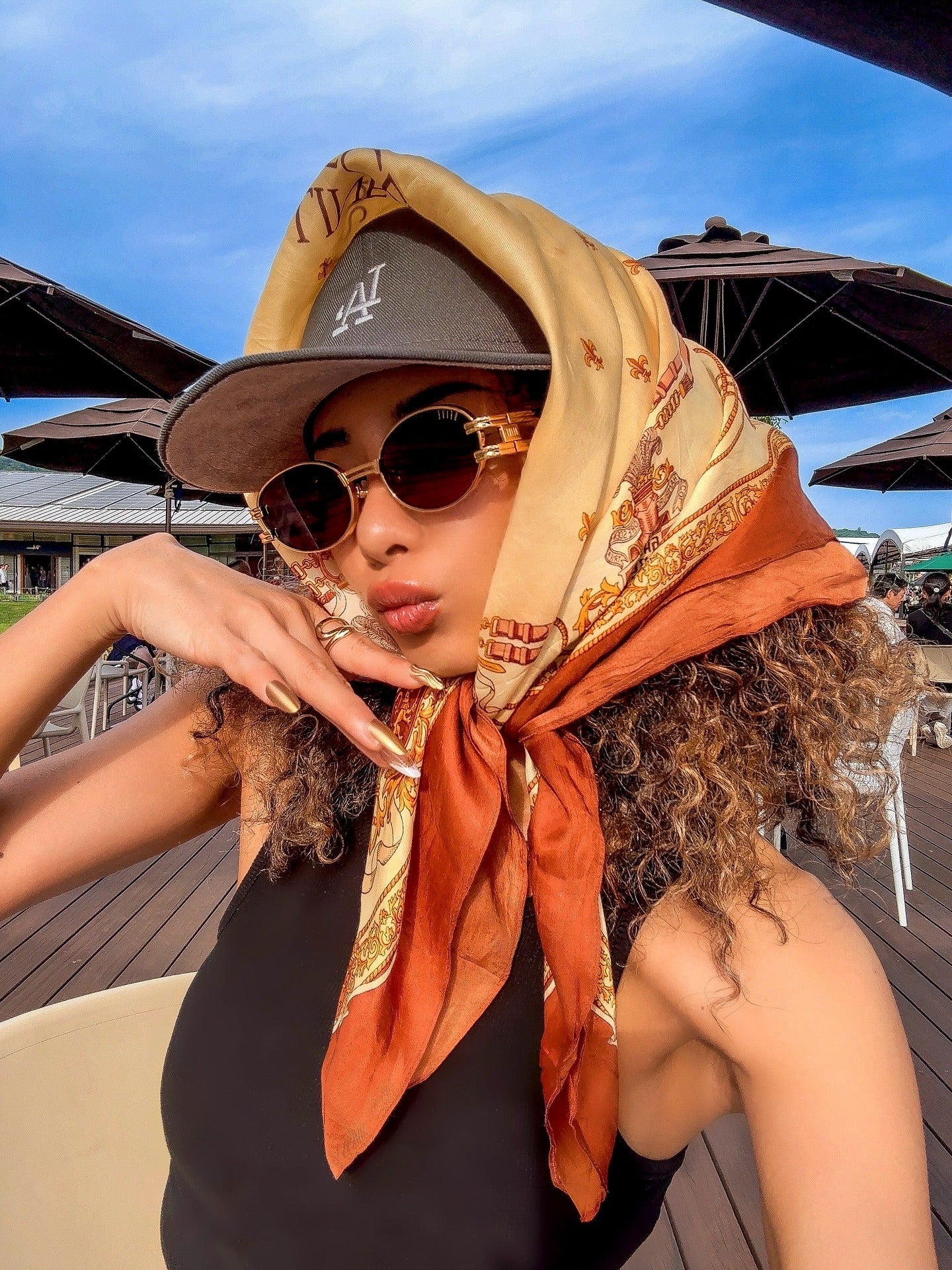 9. Layered Scarf Wrap with Cap and Curls (Bandana Hairstyles)