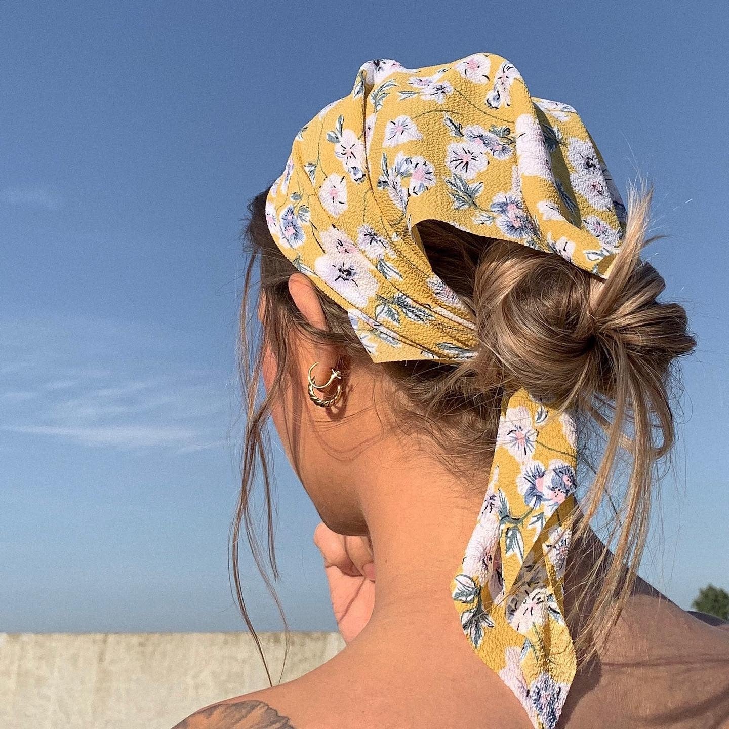 12. Yellow Floral Bandana with Low Messy Bun (Bandana Hairstyles)