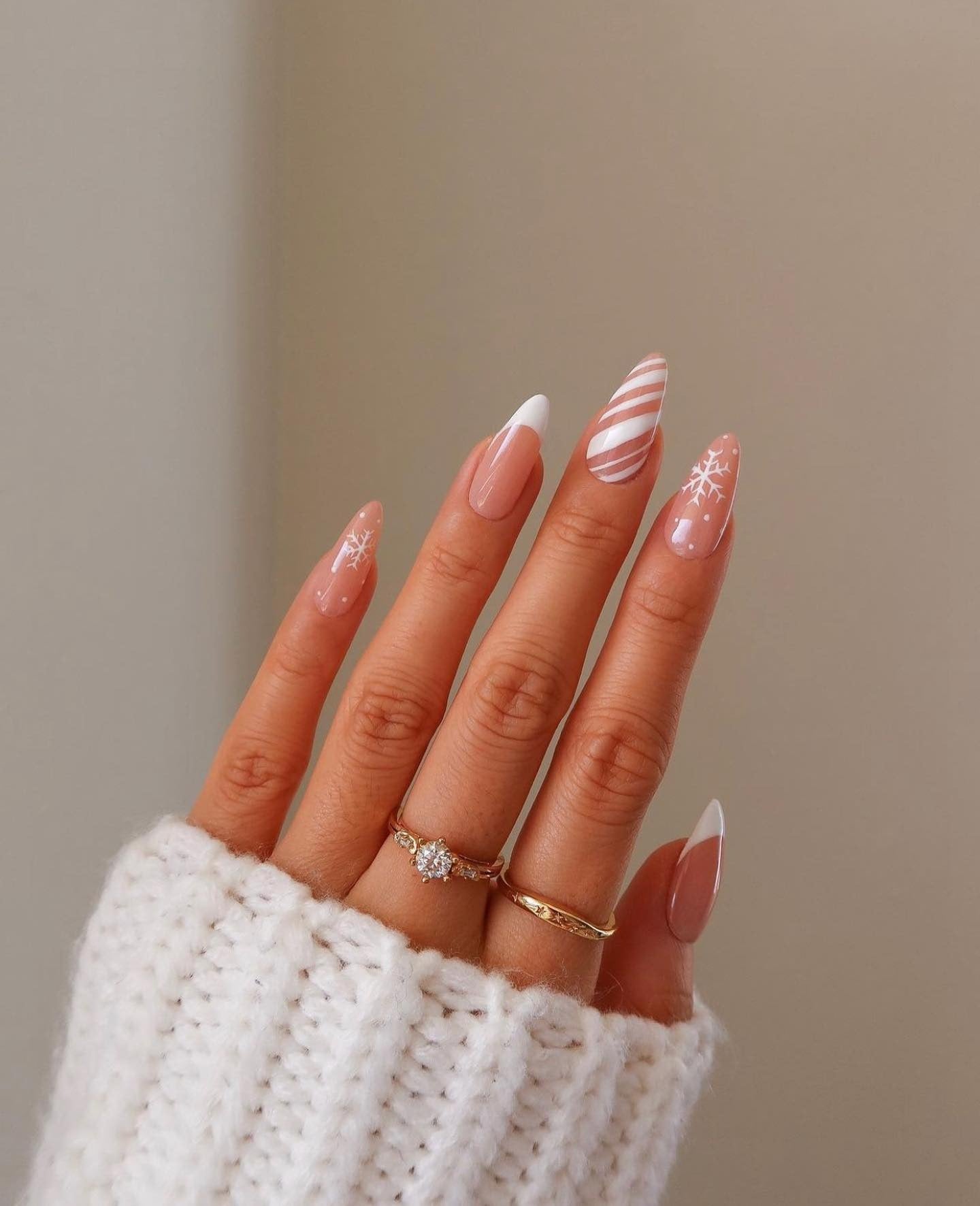 13. Candy Stripe & Snowflake Almond Nails (Winter Nail Ideas)