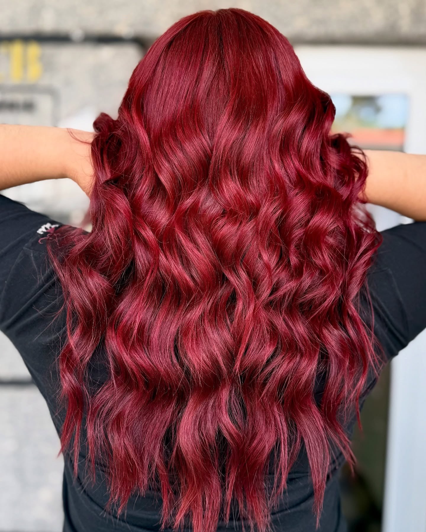 4. Cascading Glam Waves in Ruby Red (Red Hair Color)