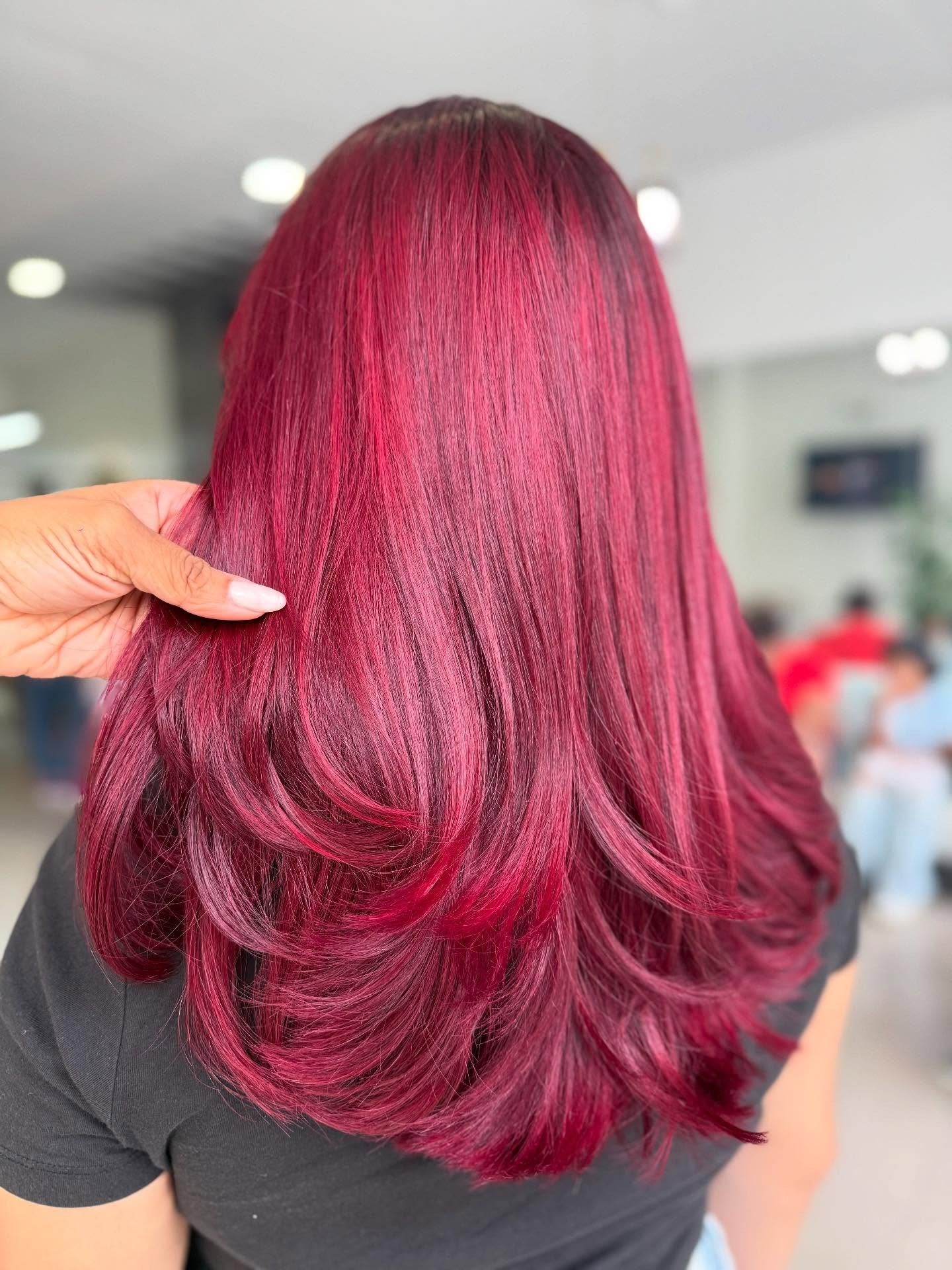 5. Feathered Layers in Vibrant Magenta-Red (Red Hair Color)