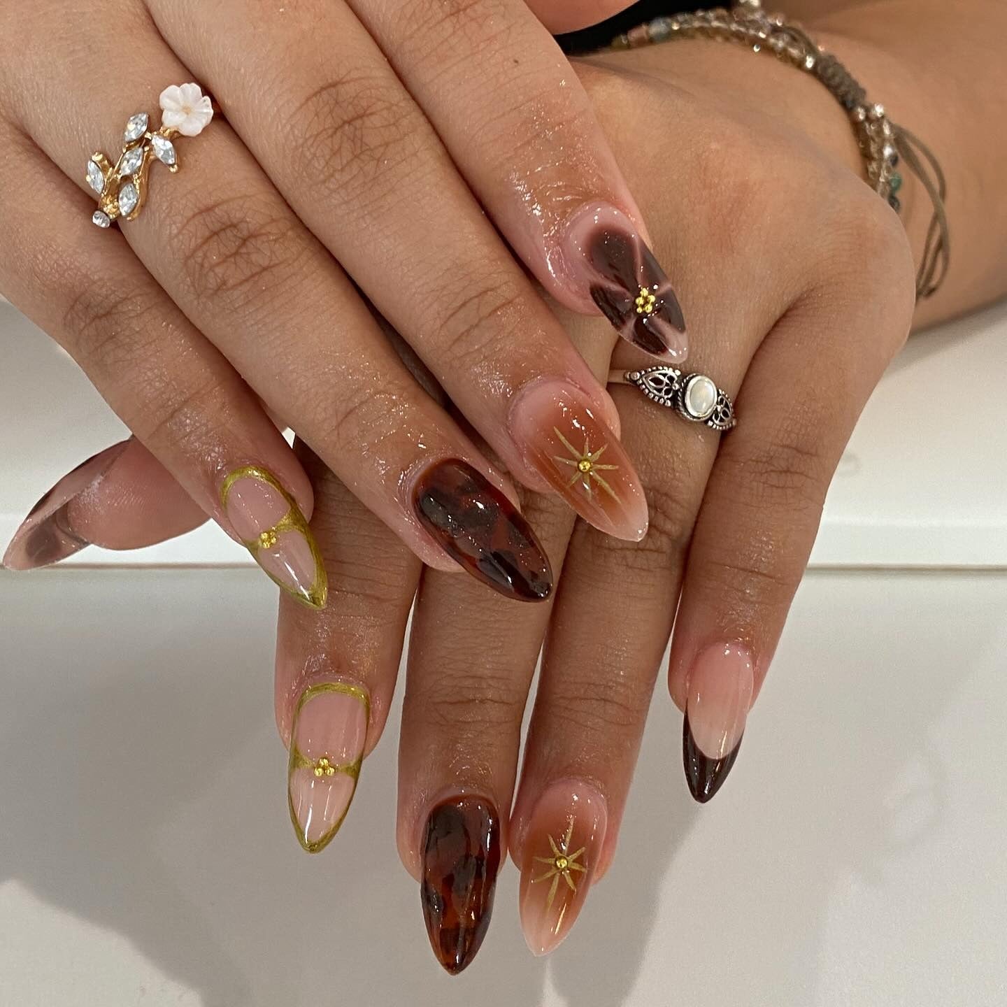 11. Tortoiseshell and Gold Accent Mix (Brown Nail Ideas)