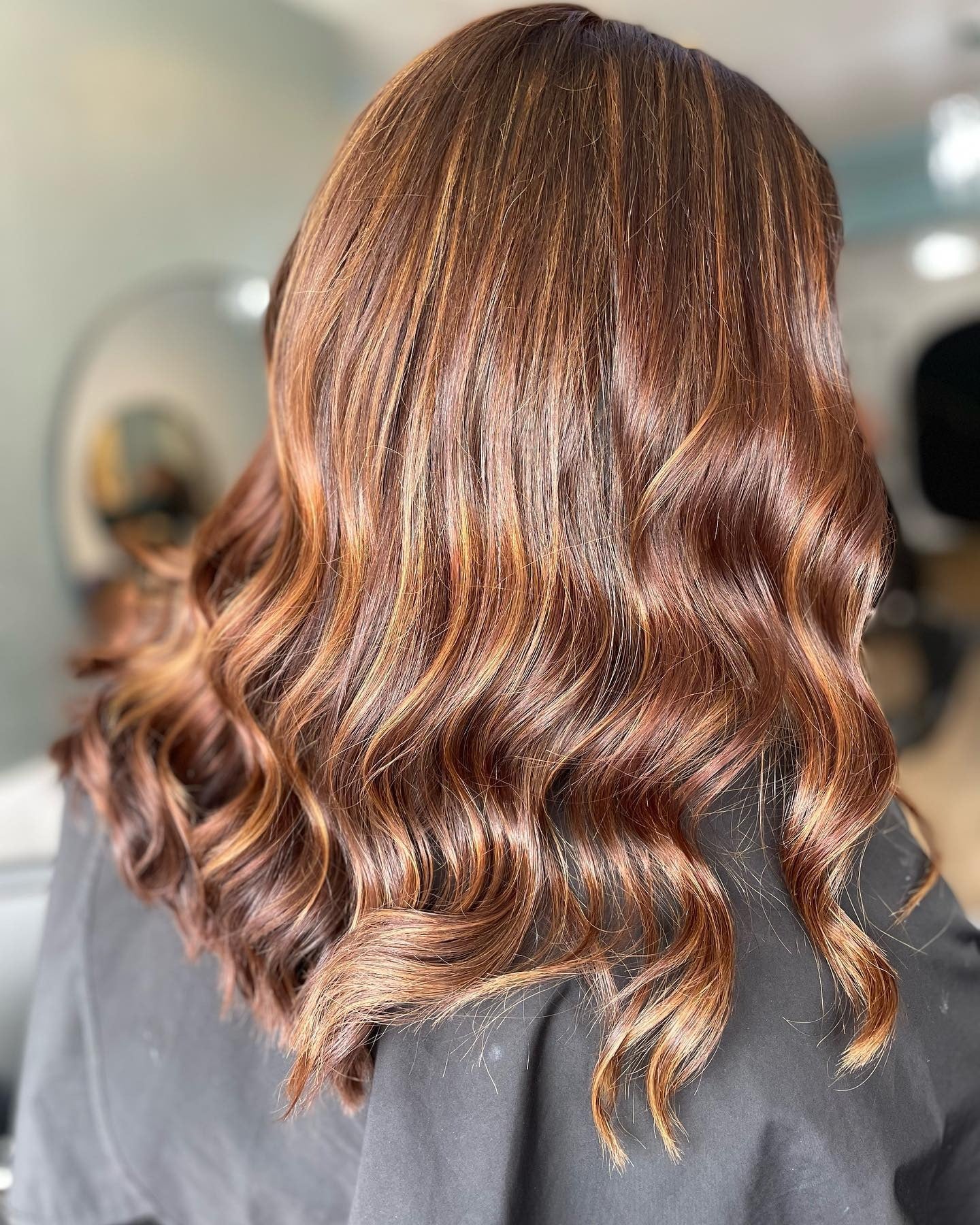 12. Golden Chestnut Waves with Seamless Highlights (Chestnut Hair Color)