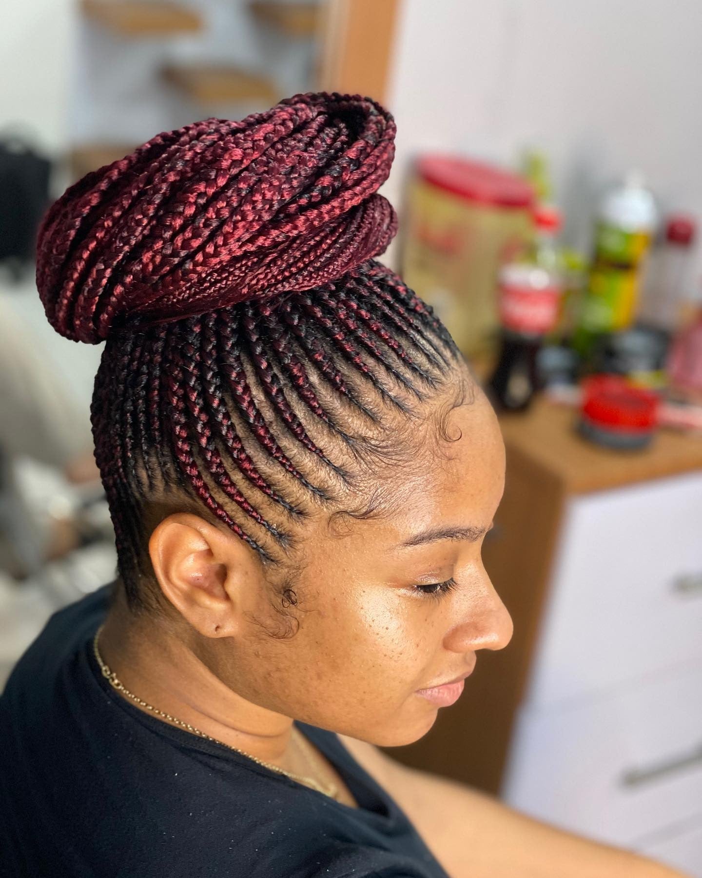 7. Burgundy Braided Bun (Cornrow Hairstyles)