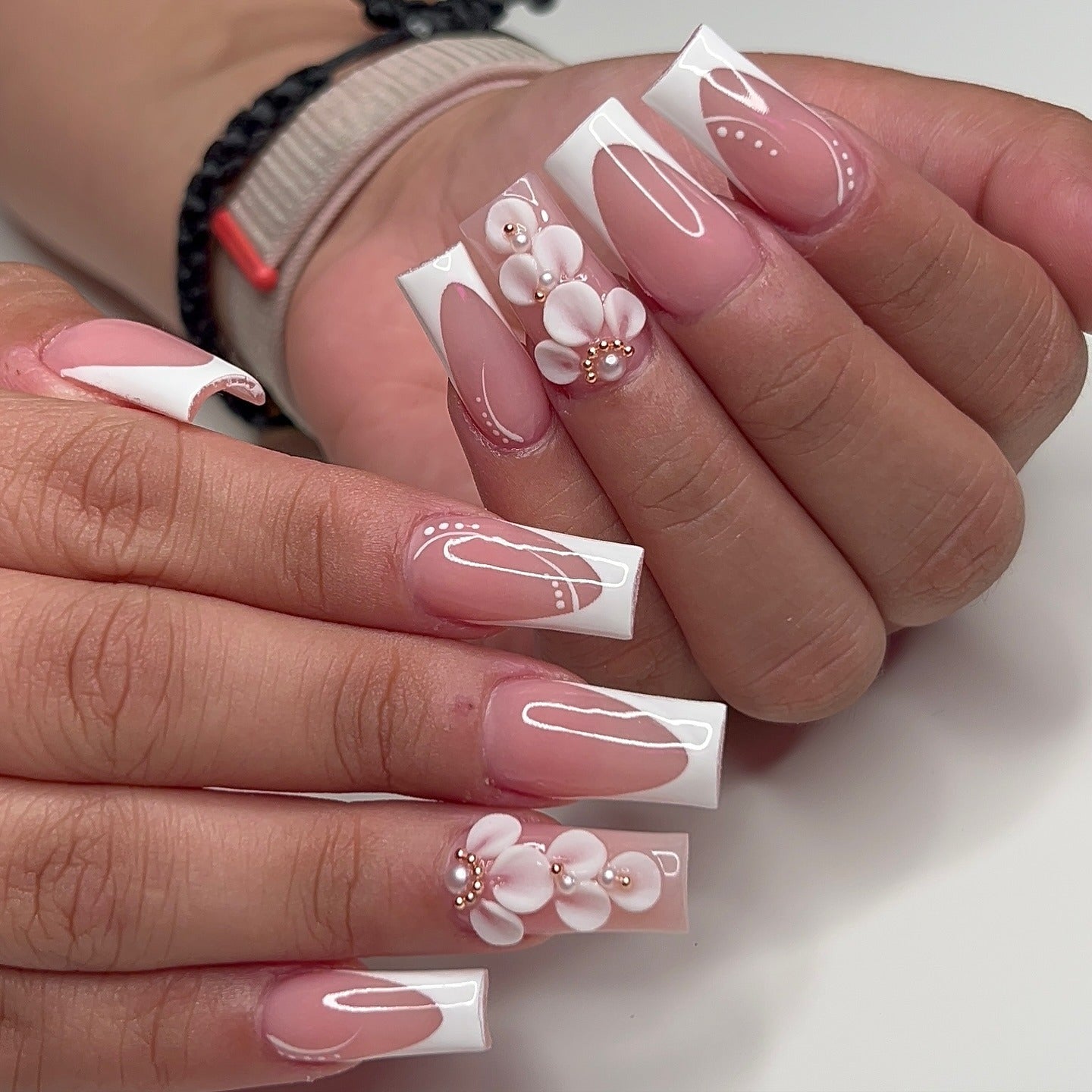 16. Modern White Floral on Glossy Coffin Tips (Flower Nail Ideas)