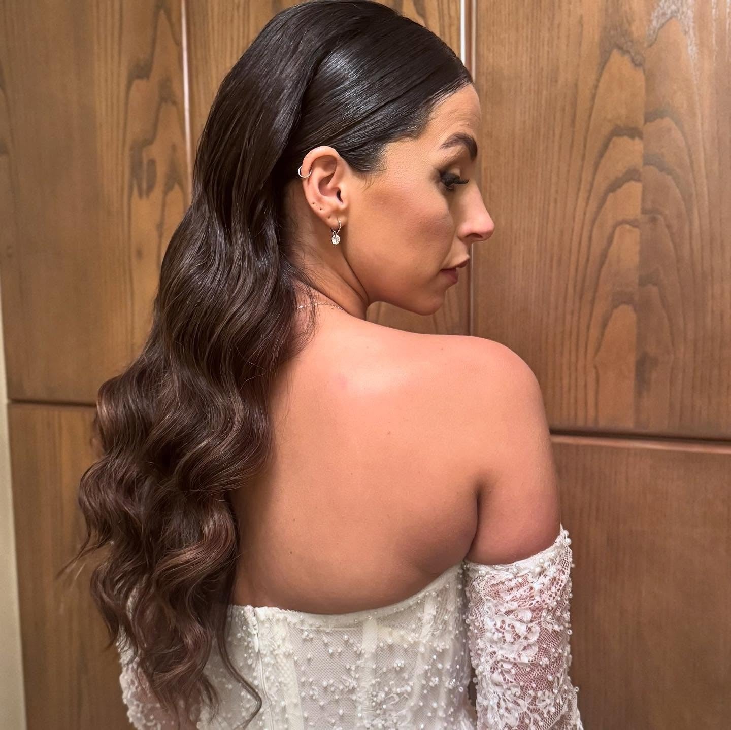 5. Glossy Low Pony with Sculpted Waves (Bride Hairstyles)