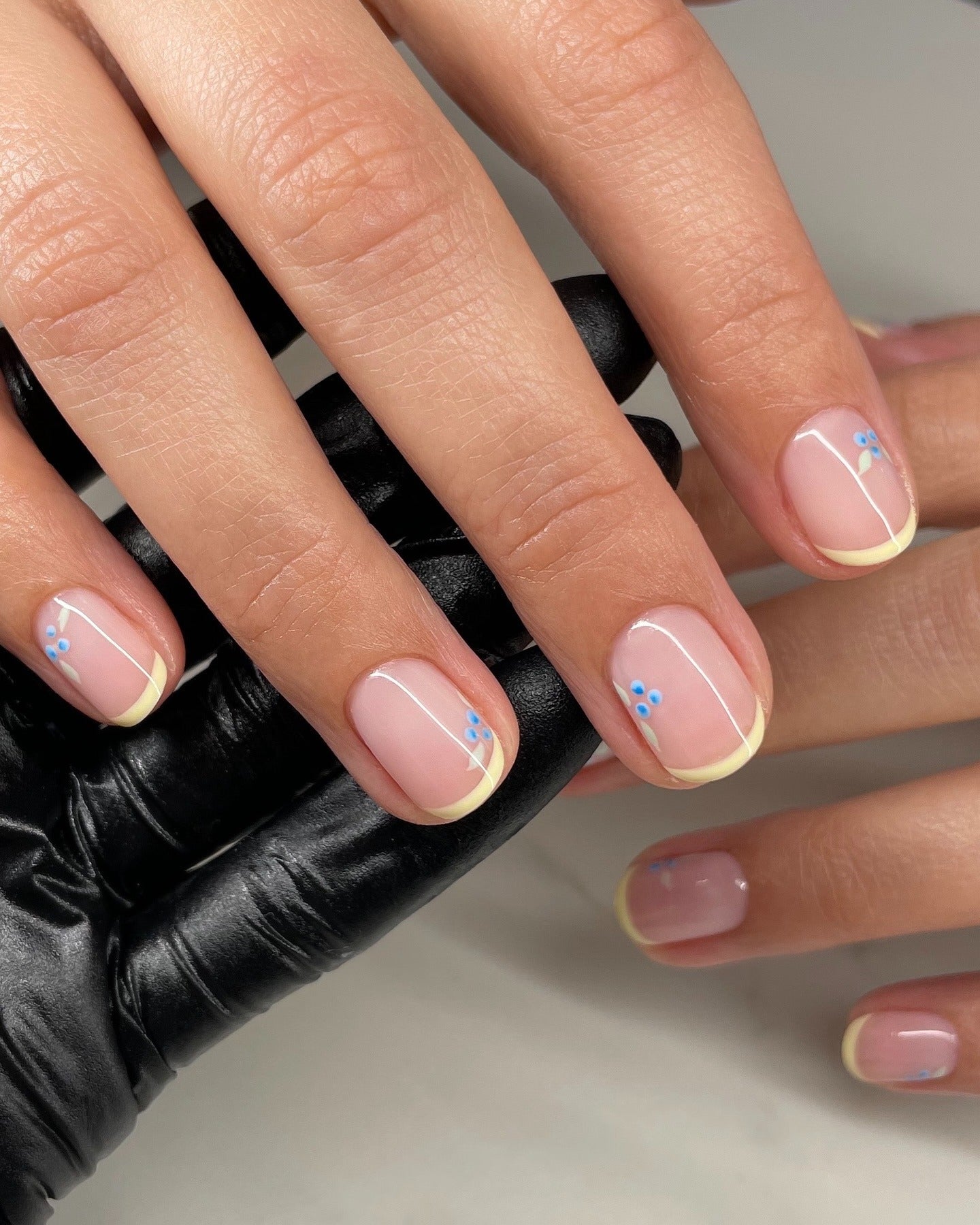 2. Floral Accent Yellow Tips (Yellow French Tip Nail Ideas)