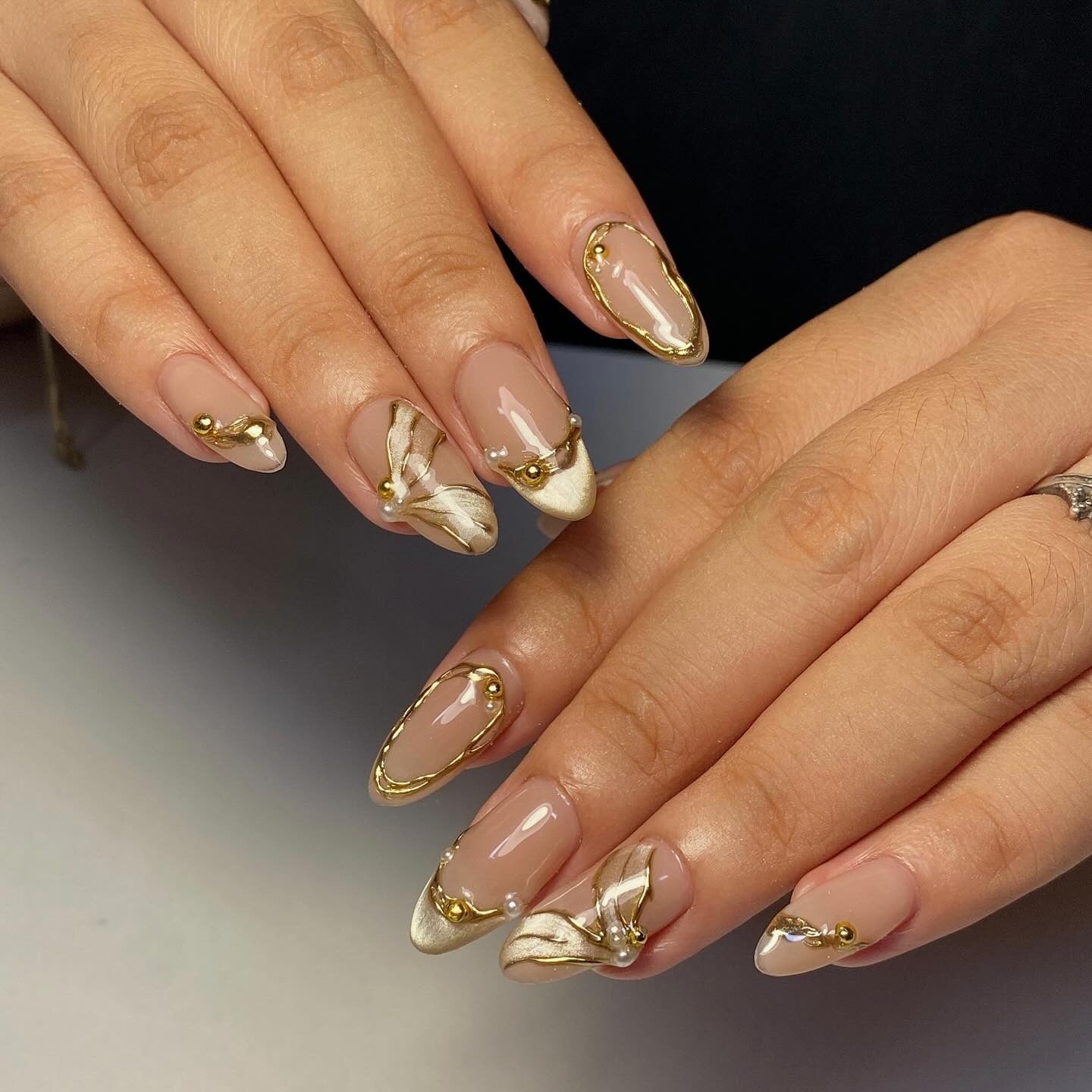 6. Gold-Edged 3D Accent Almonds (Classy Nail Ideas)