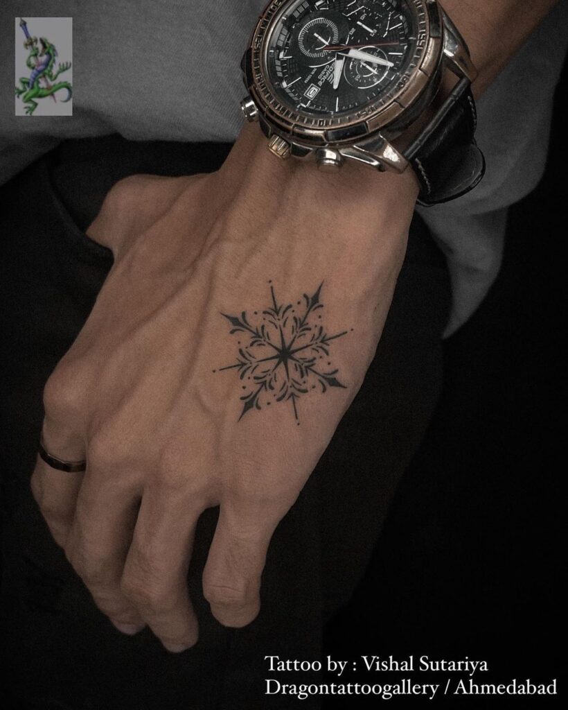 Small Snowflake Hand Tattoo