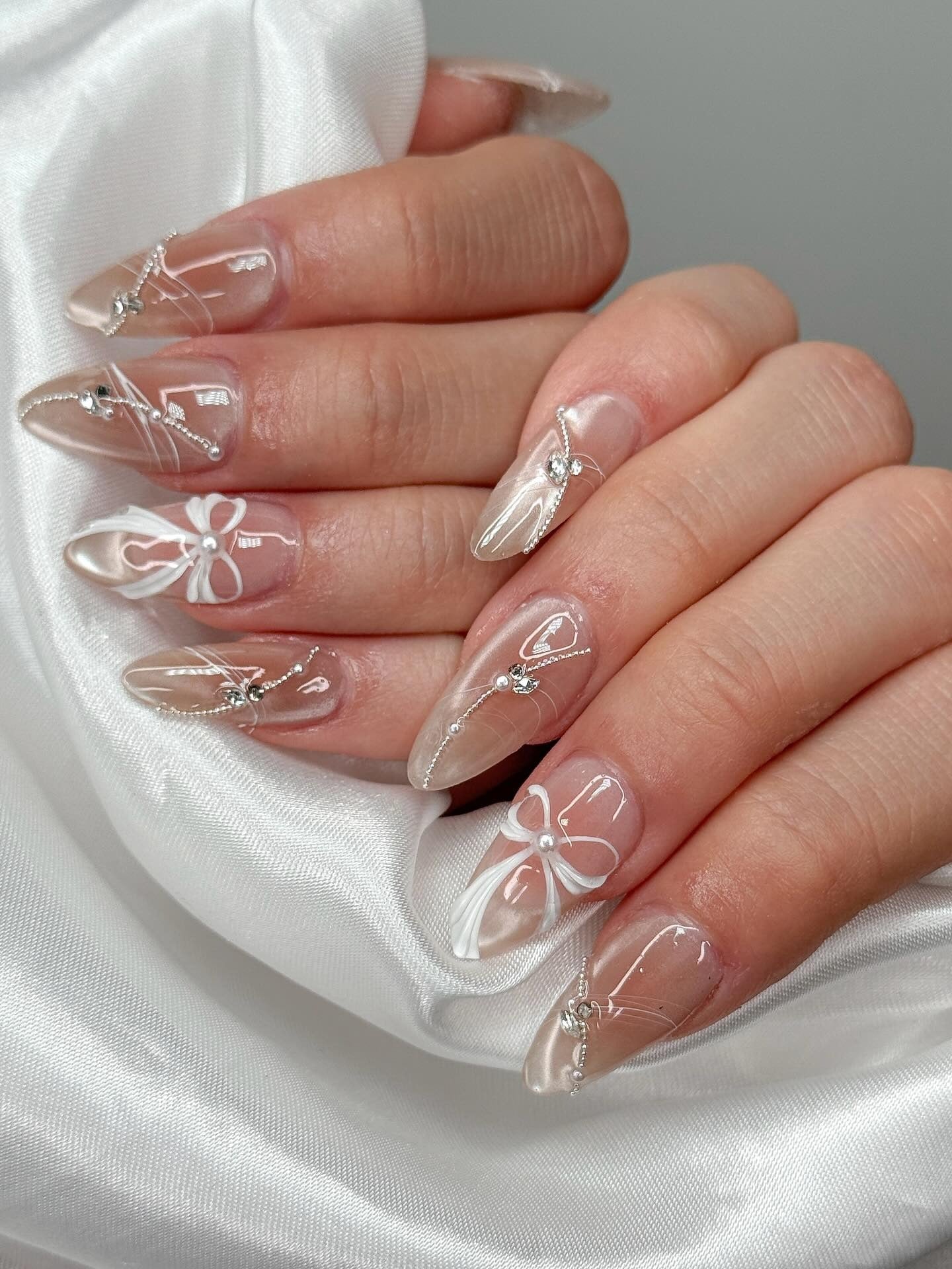 1. Pearl Bow Elegance with Nude Shine (Elegant Nail Ideas)