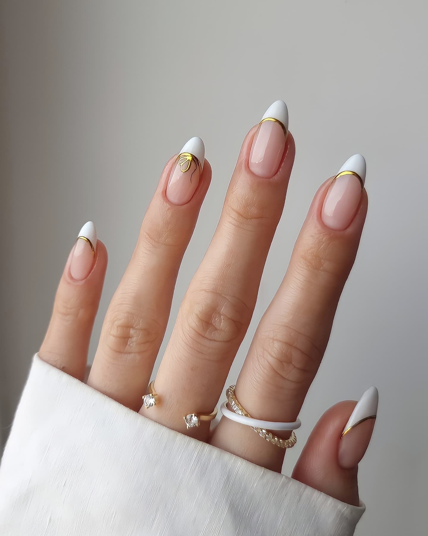 9. Modern French with Gold Detail (Elegant Nail Ideas)