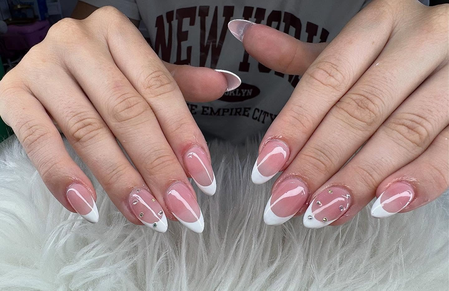 2. Classic White Angle Tips with Gem Accents (Almond Nail Ideas)