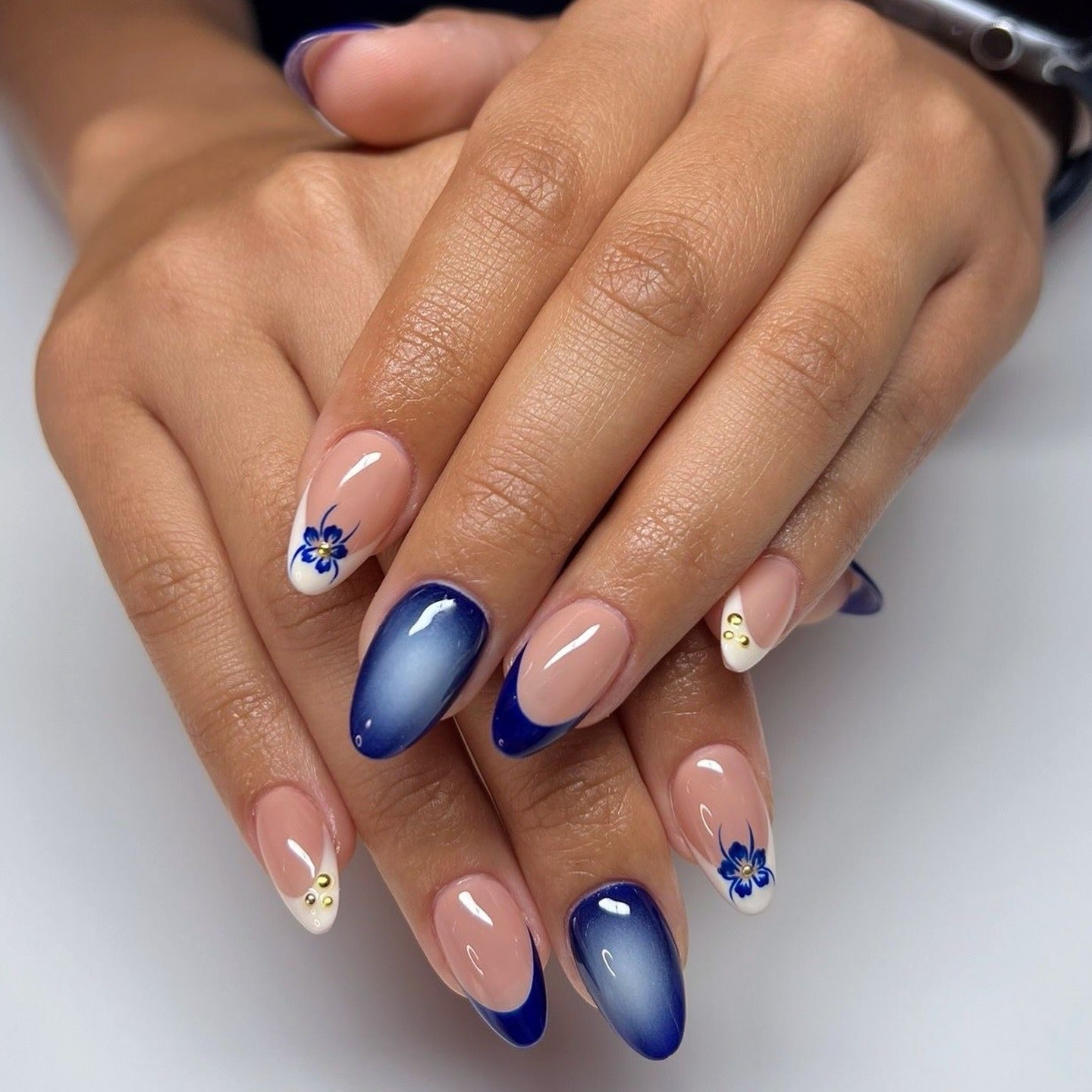 8. Blue Ombre with Floral Accents (Almond Nail Ideas)