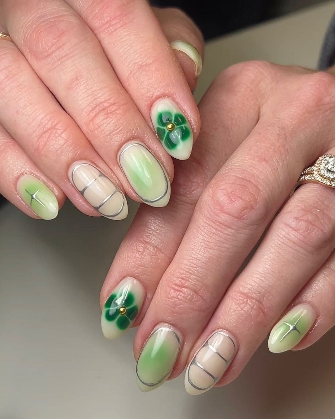 5. Translucent Lime Fade with Floral Accent (Green Nail Ideas)