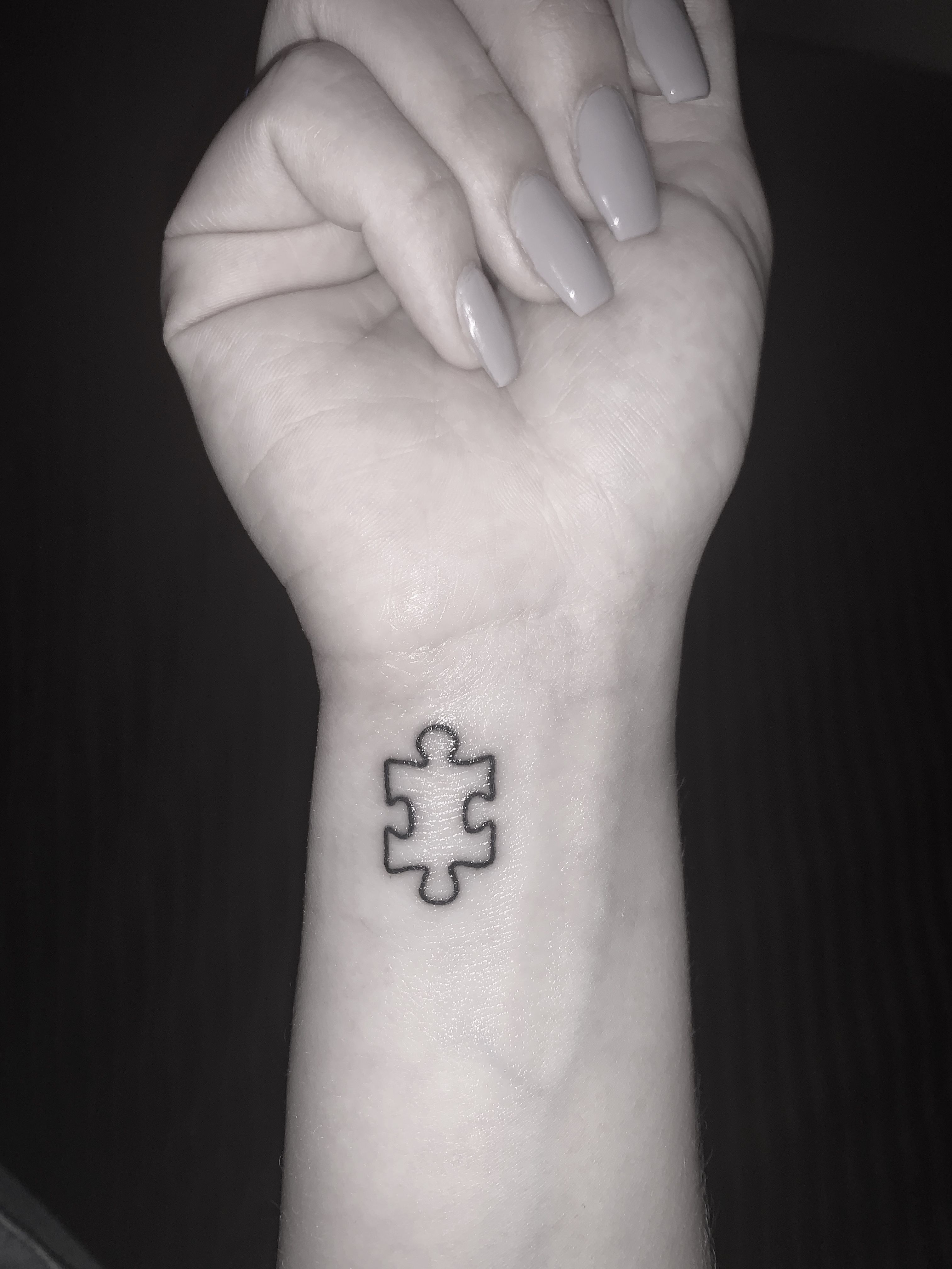 Autism puzzle piece tattoo on wrist
