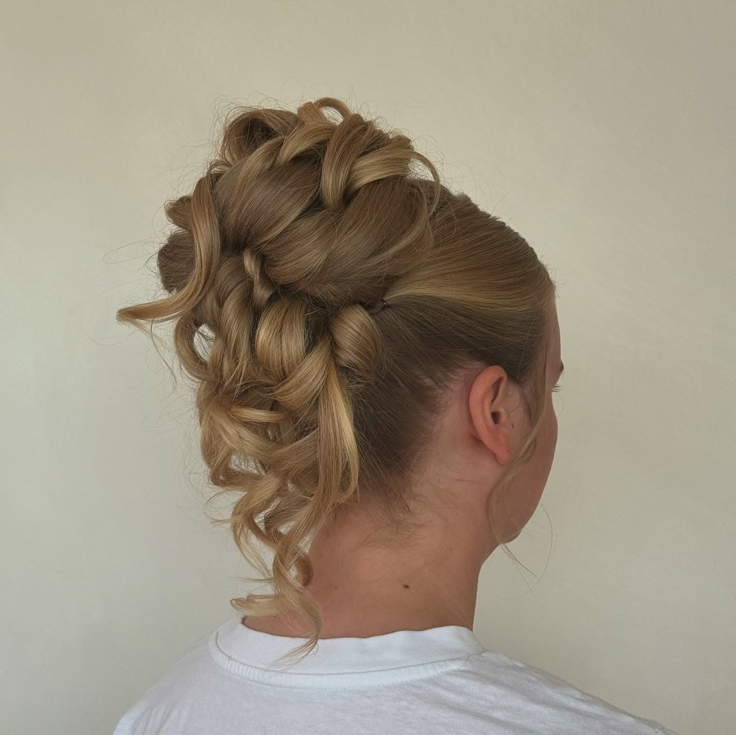 9. Braided Caramel Blonde Curly Bun (Updo Hairstyles)