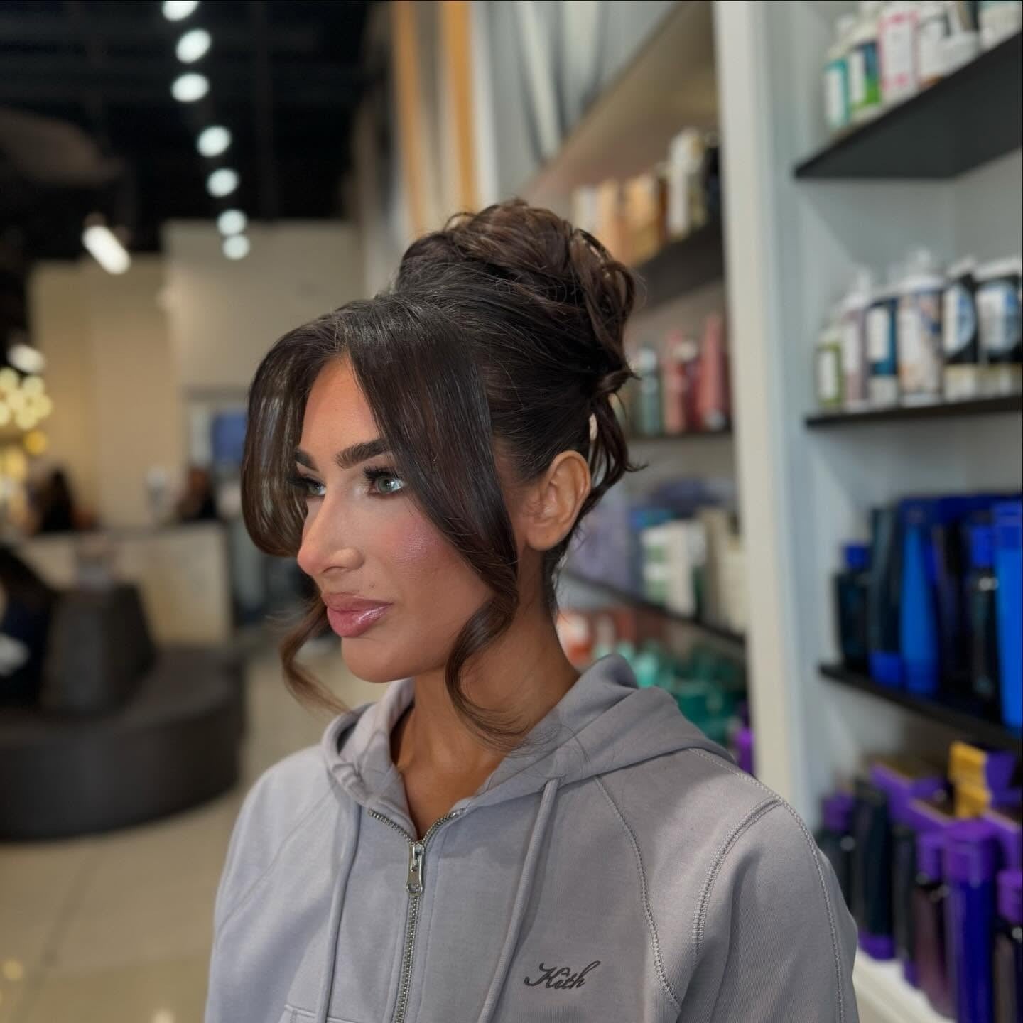 18. Brunette Voluminous High Bun with Face-Framing Layers (Updo Hairstyles)