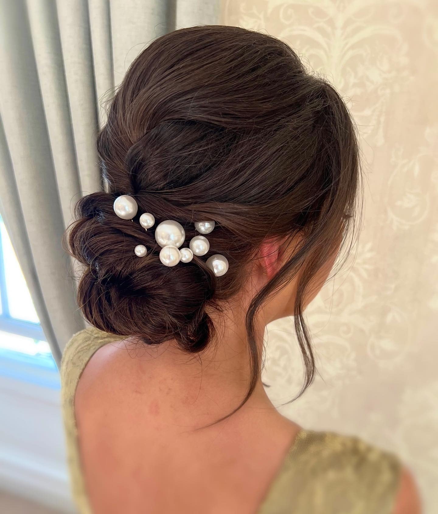 1. Elegant Low Chignon with Pearl Accents on Rich Brunette (Bridesmaid Hairstyles)