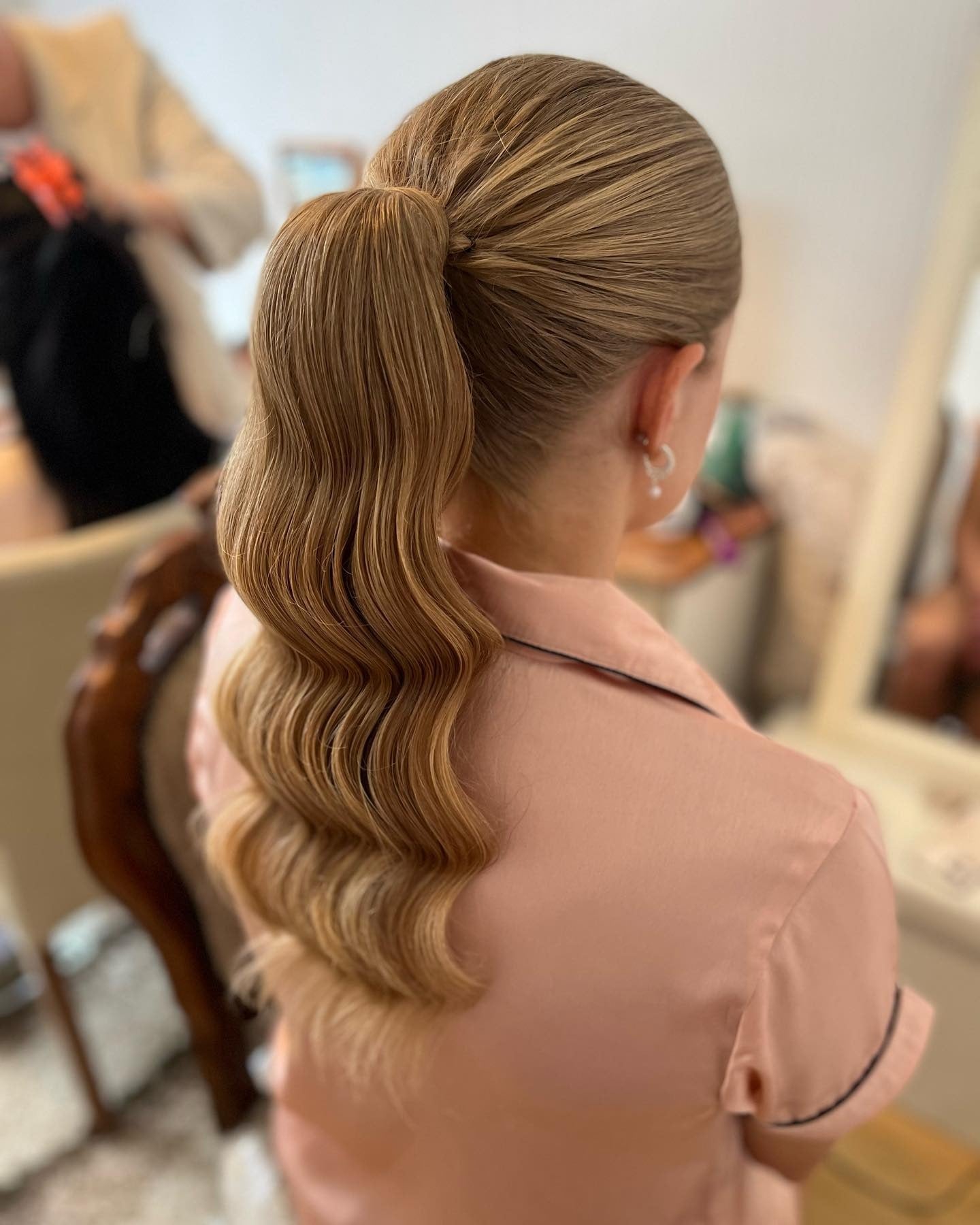 3. Sleek Wrapped Ponytail with Soft Waves in Golden Blonde (Bridesmaid Hairstyles)