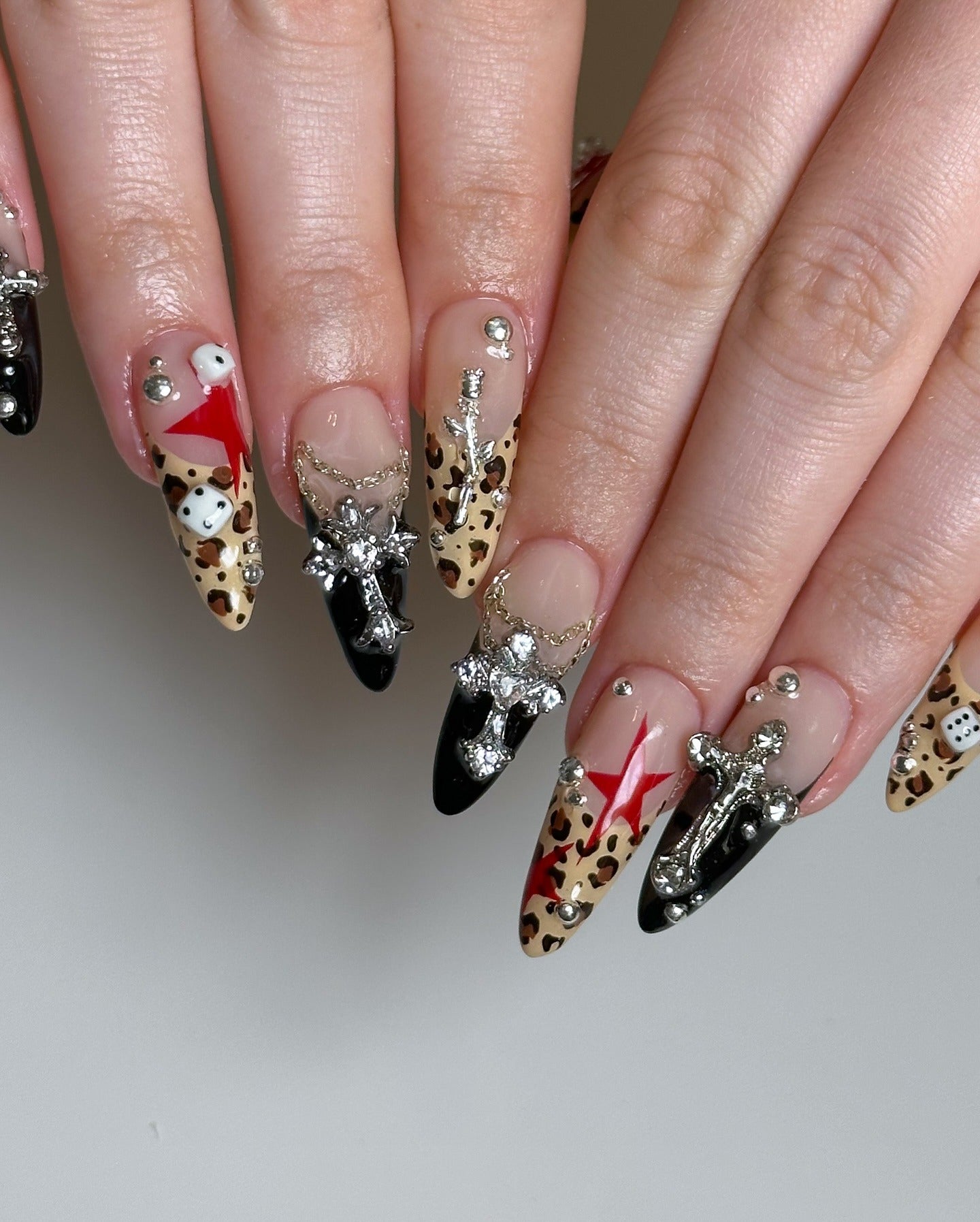 3. Leopard Luxe with Silver Cross Charms (Cheetah Nail Ideas)
