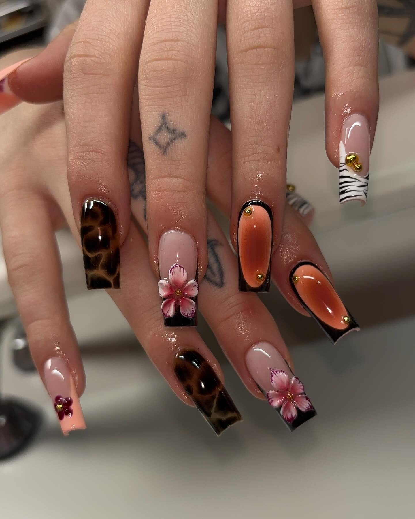 17. Sunset Amber Leopard with Floral Framing (Cheetah Nail Ideas)