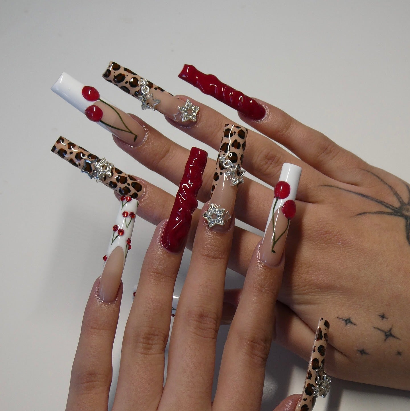 18. Cherry Leopard with Silver Star Charms (Cheetah Nail Ideas)