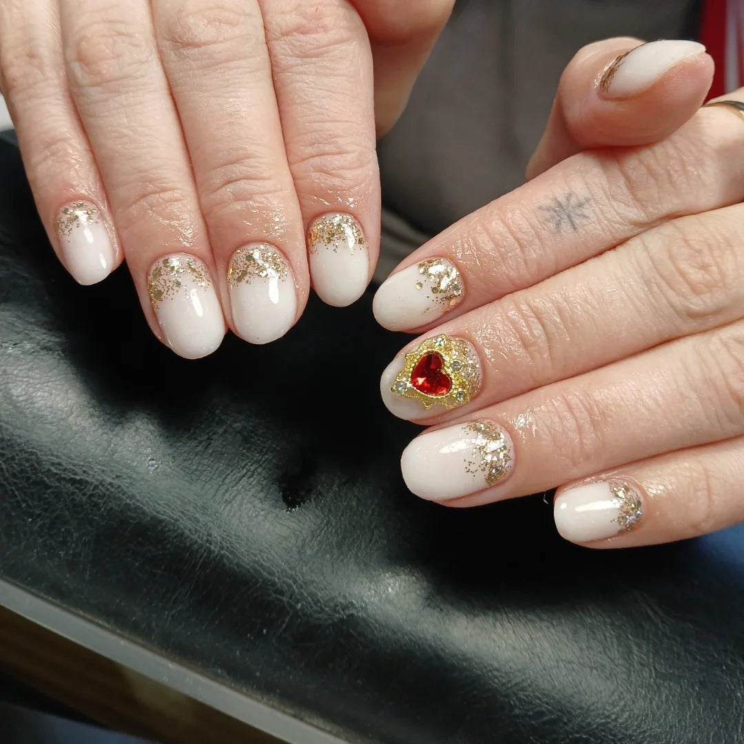 10. Milky Glitter Nails with Red Heart Accent (Milky Nail Ideas)