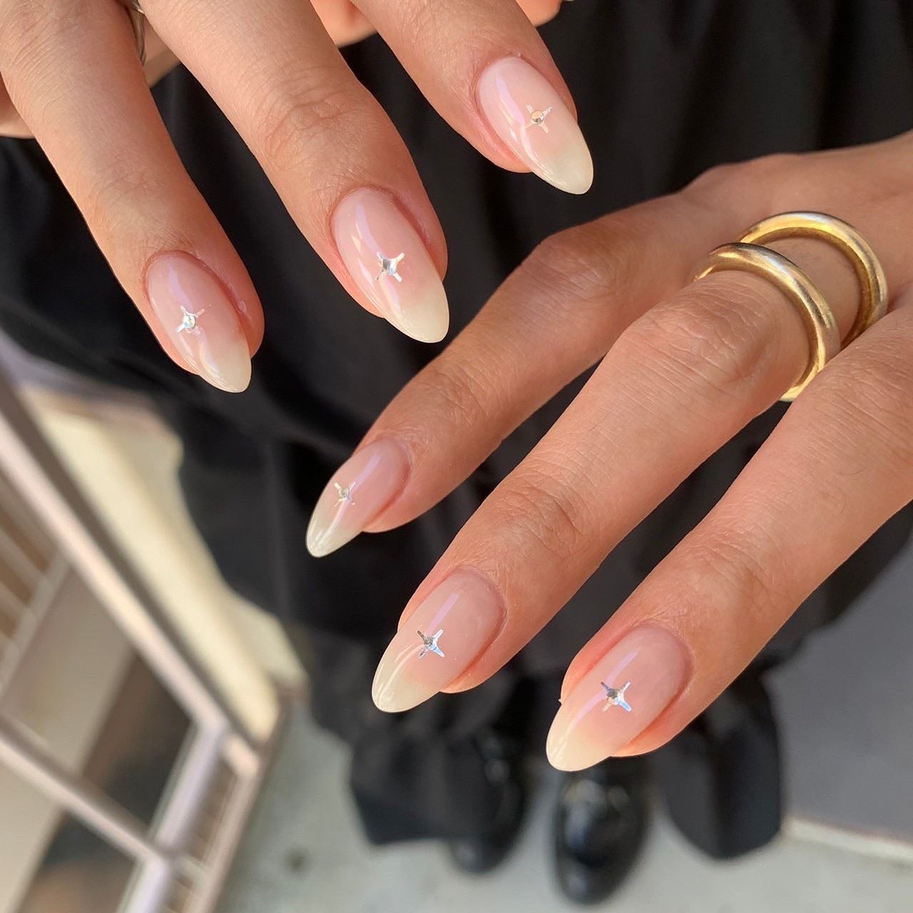 12. Minimal Milky Almond Nails with Star Studs (Milky Nail Ideas)