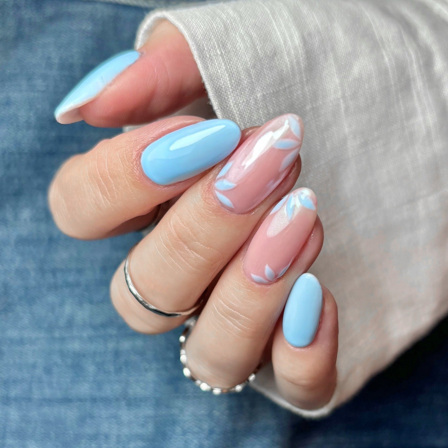 13. Soft Blue and Nude Nails with Leaf Accents (Light Blue Nail Ideas)