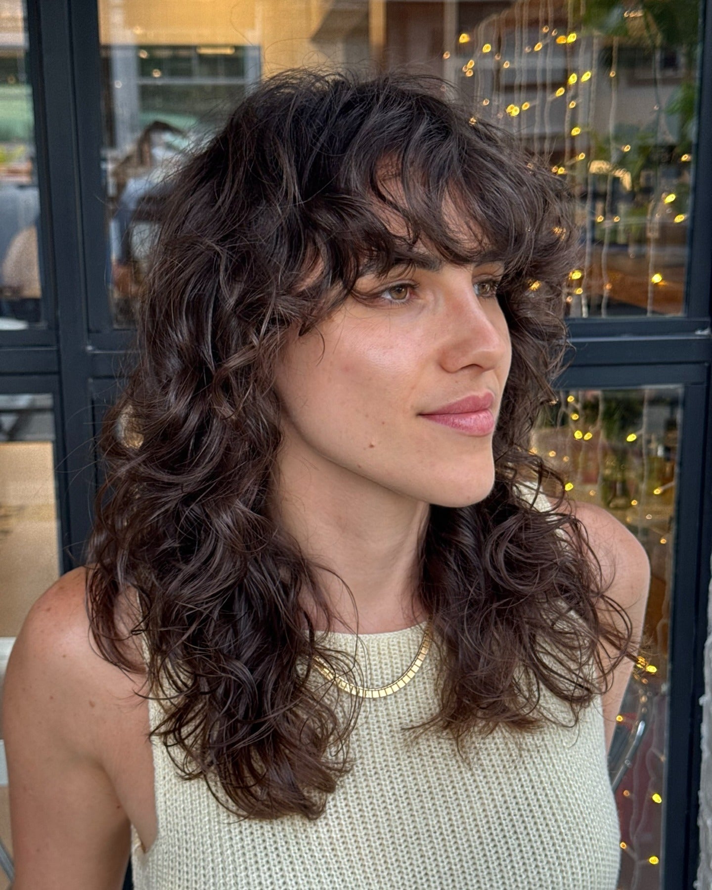 6. Mid-Length Curly Shag with Soft Fringe (Shaggy Haircut)