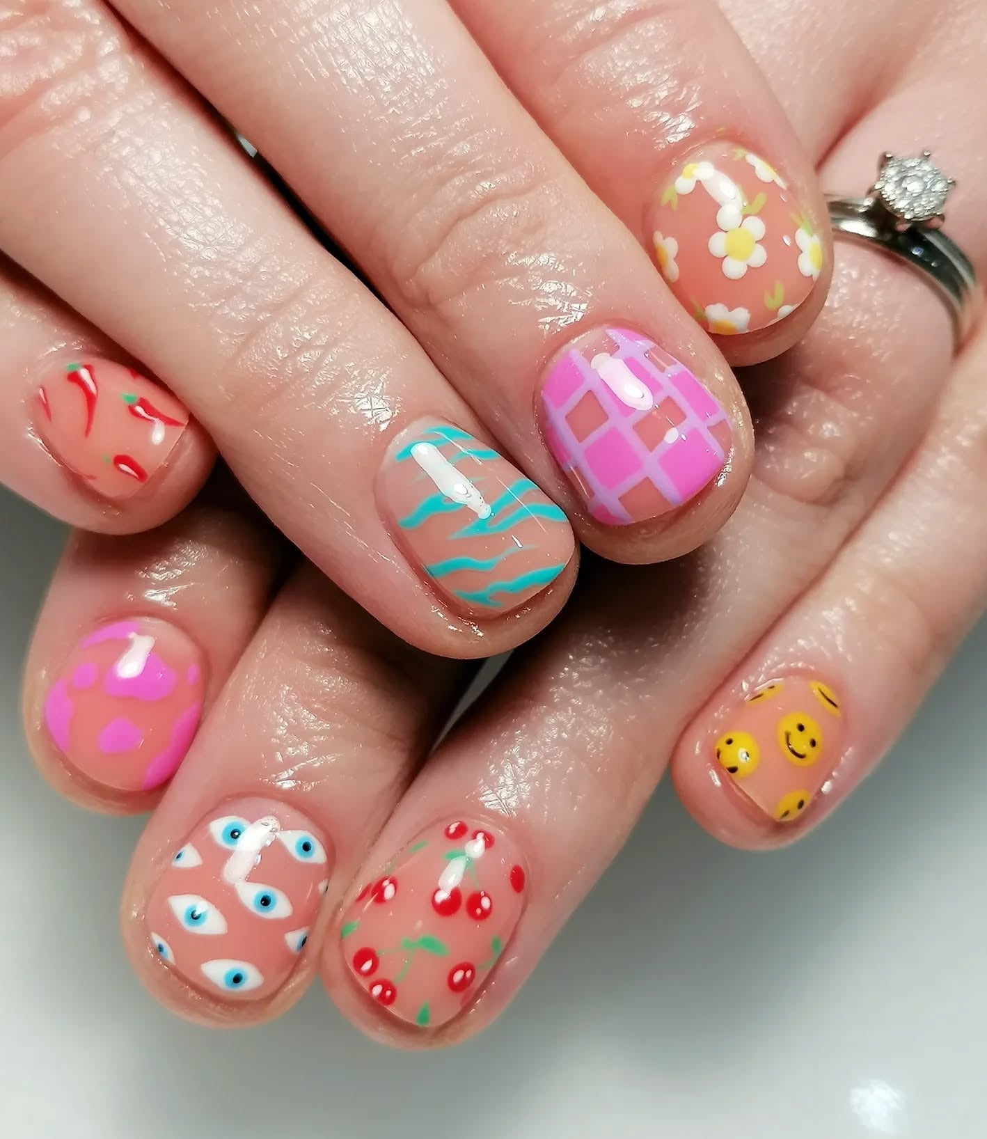 3. Retro Mixed Icons on Coral Base (Short Nail Ideas)