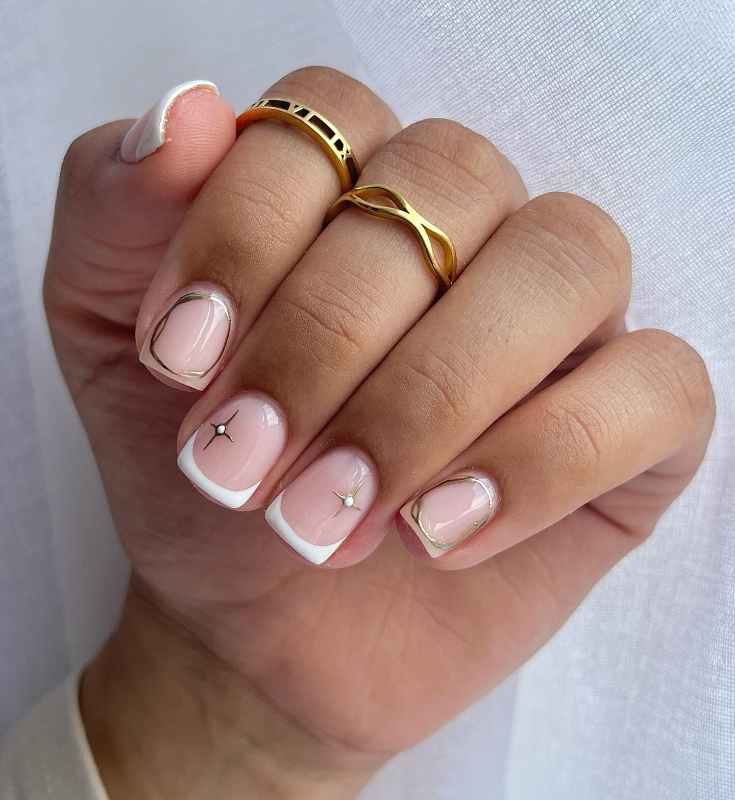 12. Gold-Edged French with Mini Stars (Short Nail Ideas)