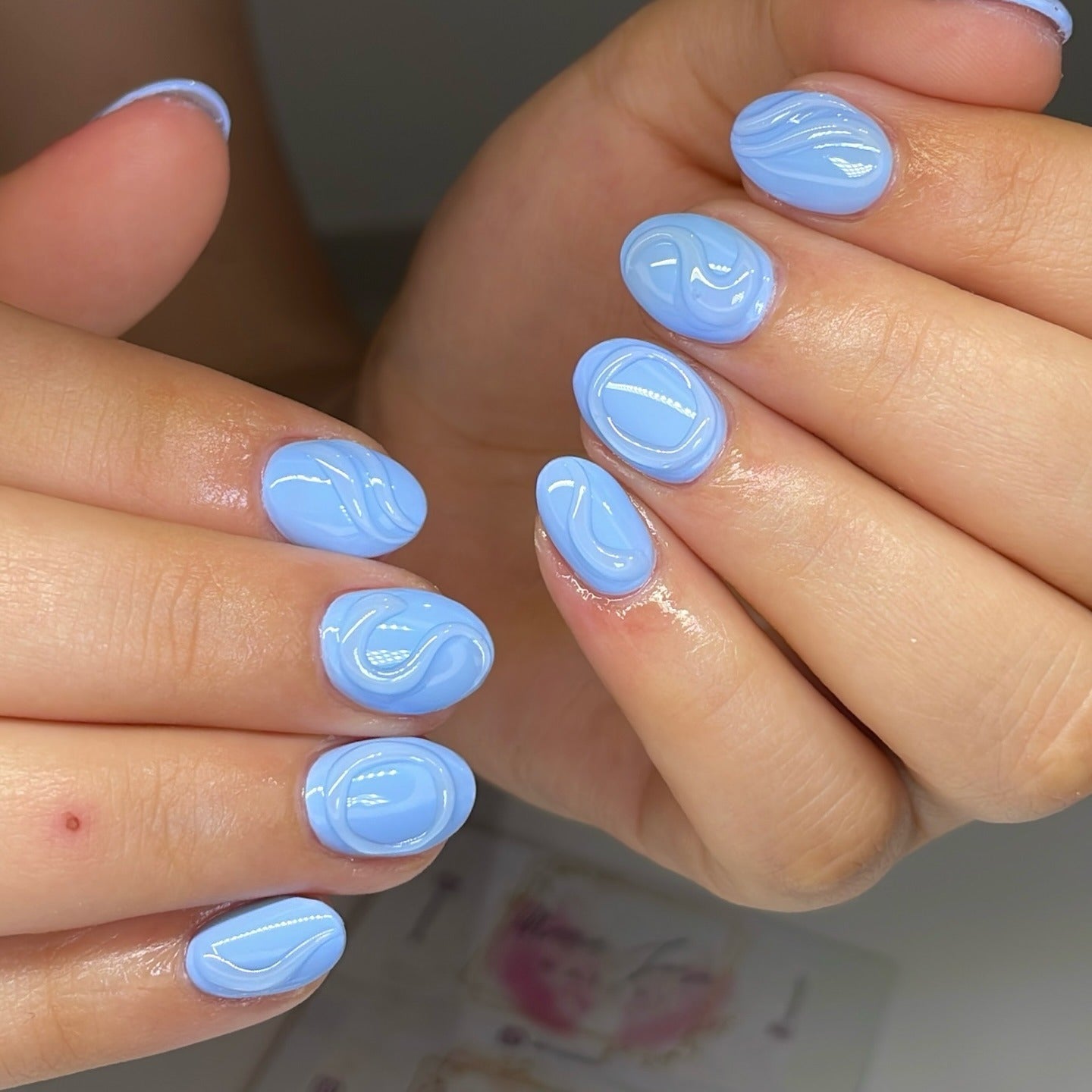 15. Baby Blue Gloss with Glossy Swirls (Blue Spring Nail Ideas)
