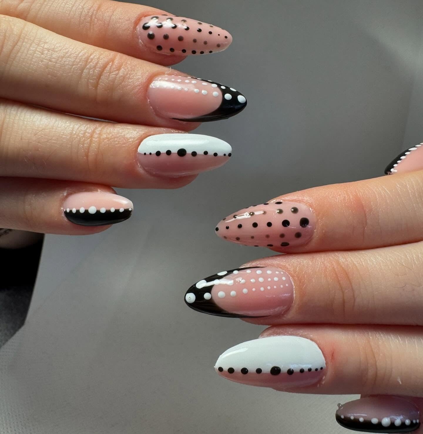 1. Polka Dot Elegance on Almond Tips (Black and White Nail Ideas)