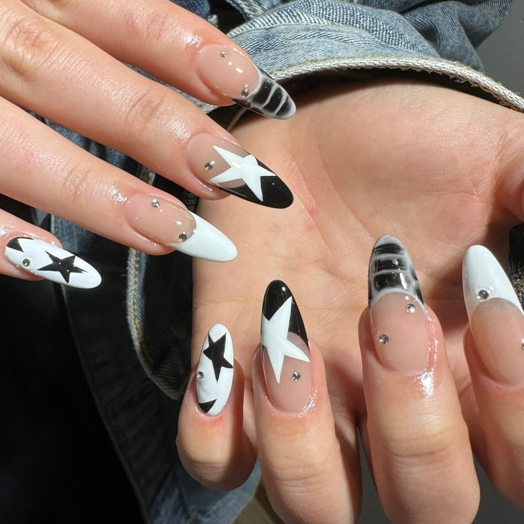 8. Celestial Stars with Subtle Rhinestones (Black and White Nail Ideas)