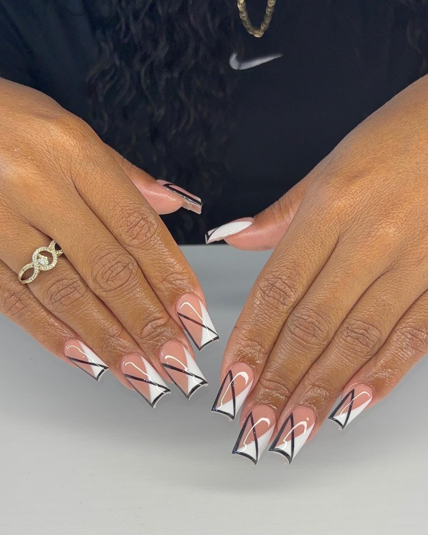 16. Angular French Illusion in Geometric Tips (Black and White Nail Ideas)