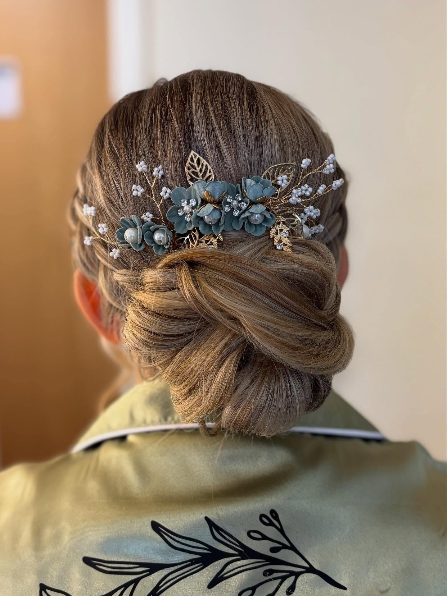 2. Low Twisted Chignon with Floral Hairpiece (Wedding Hairstyles)