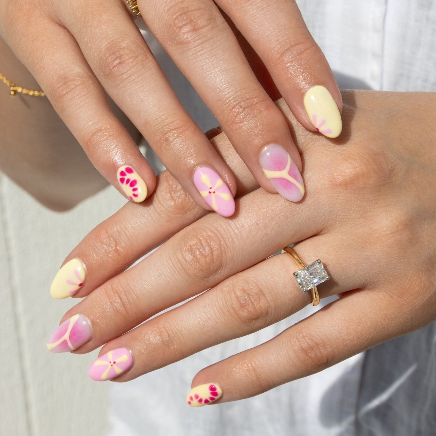 7. Pastel Bloom with Geometric Accent (Yellow and Pink Nail Ideas)