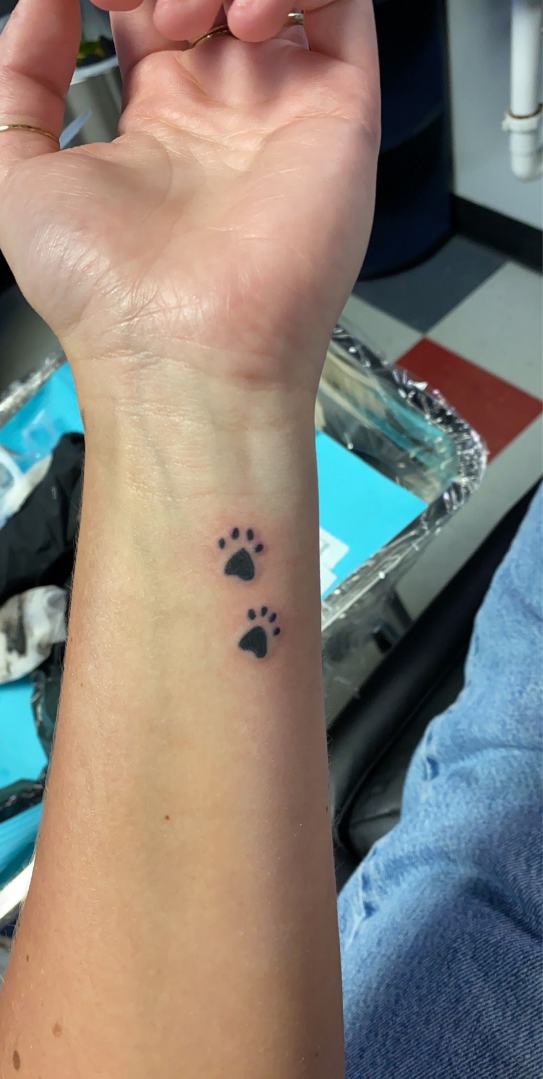 paw prints wrist tattoo