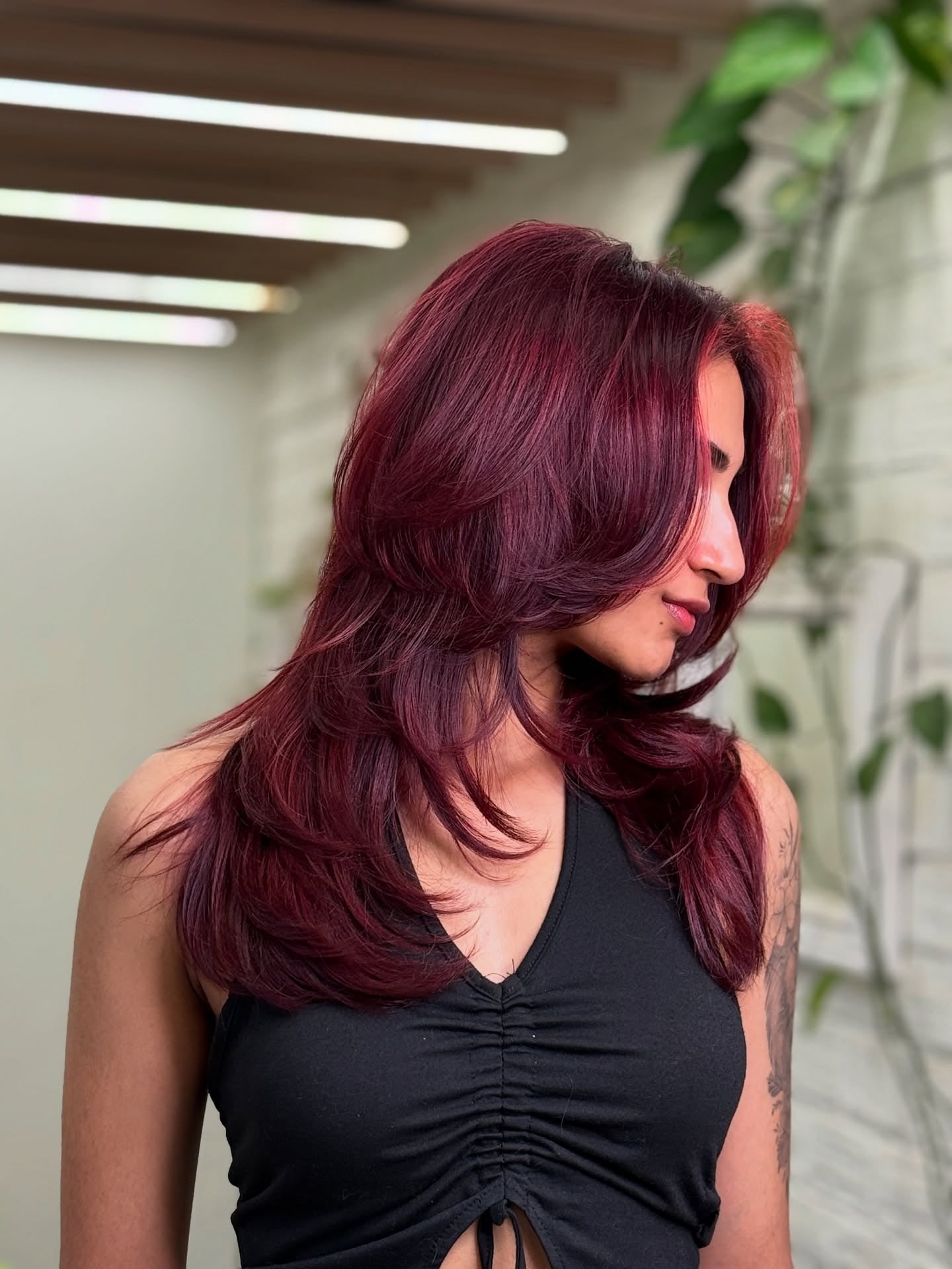 3. Voluminous Long Layers with Deep Side Flow (Cherry Cola Hair Color)