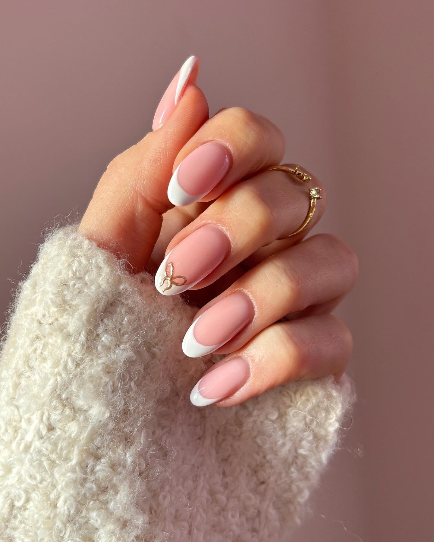 7. Minimalist White French Almond Nails with Accent Bow (French Tip Nail Ideas)