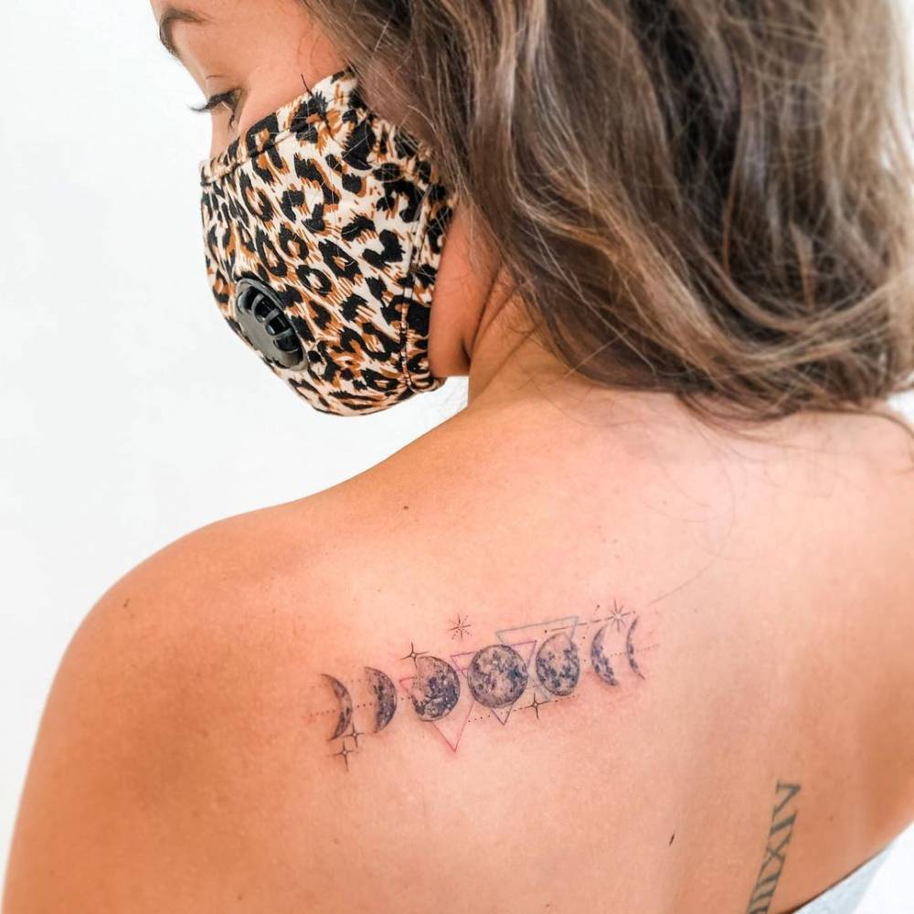 Micro-realistic moon phases tattoo on the shoulder
