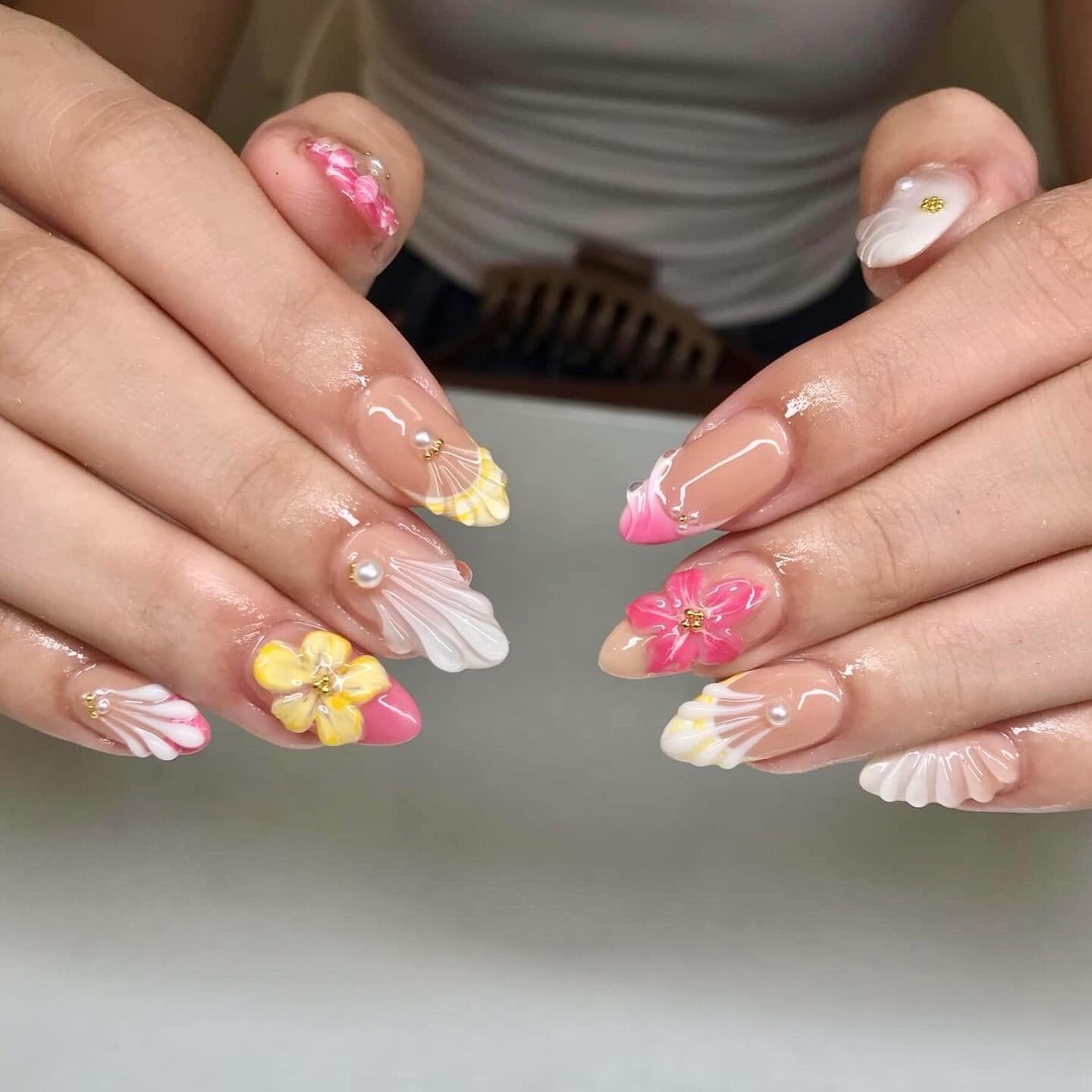 4. Tropical Bloom and Shell Carving Nails (Beach Nail Ideas)