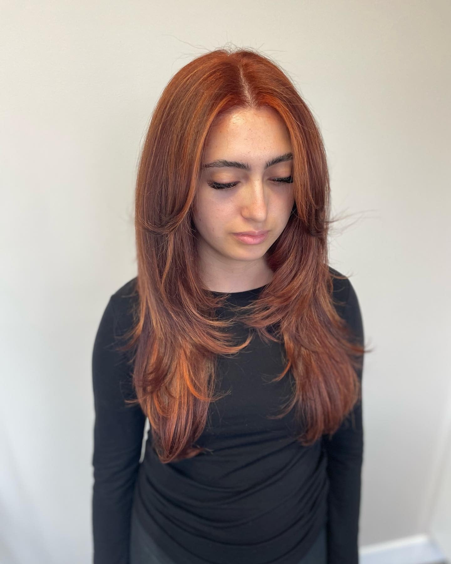 3. Sleek Layered Cut in Light Red Copper (Red Copper Hair Color)