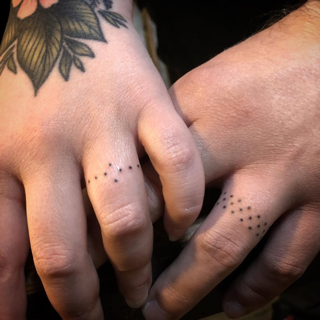 Minimalist dot pattern wedding ring tattoos