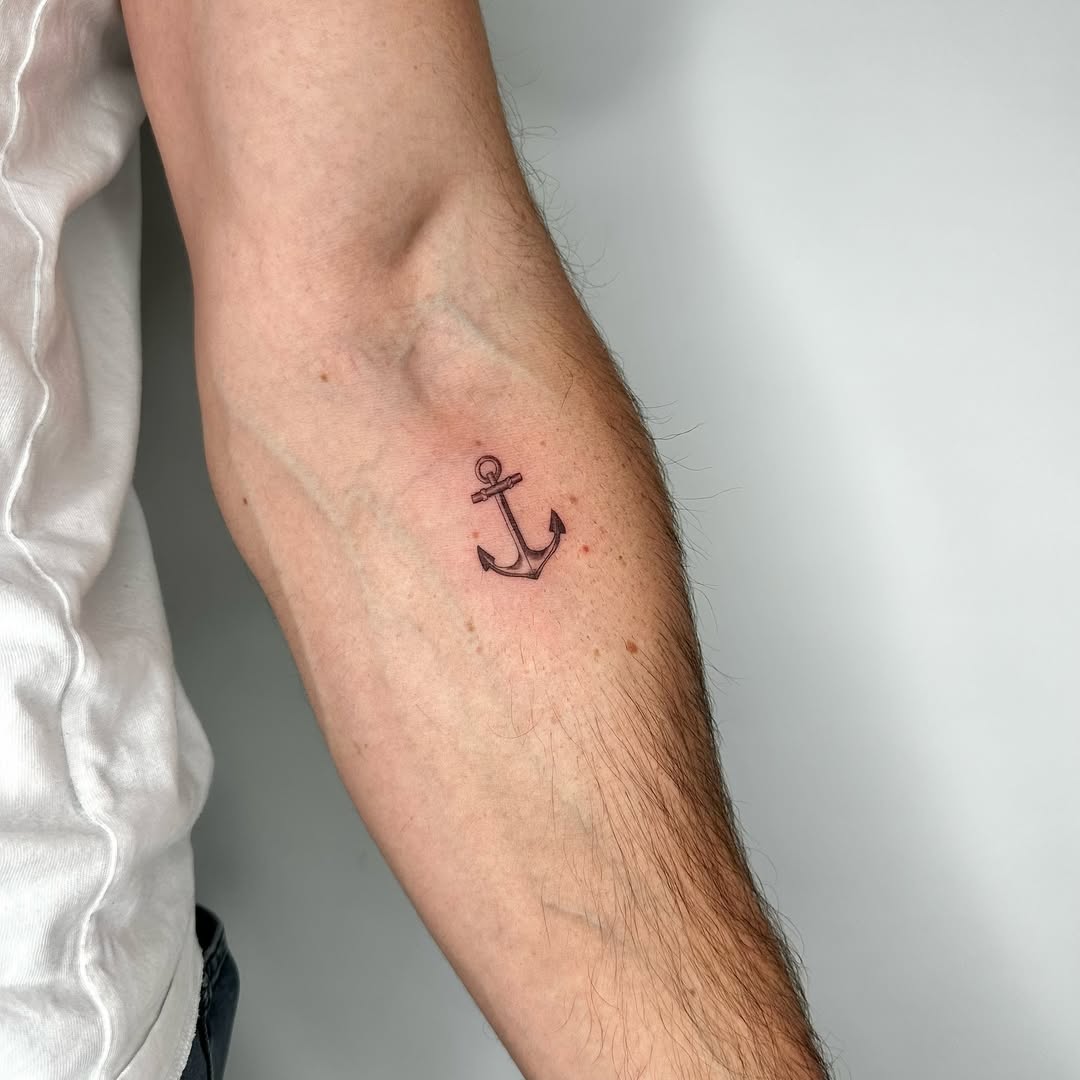 Minimalist anchor tattoo on forearm